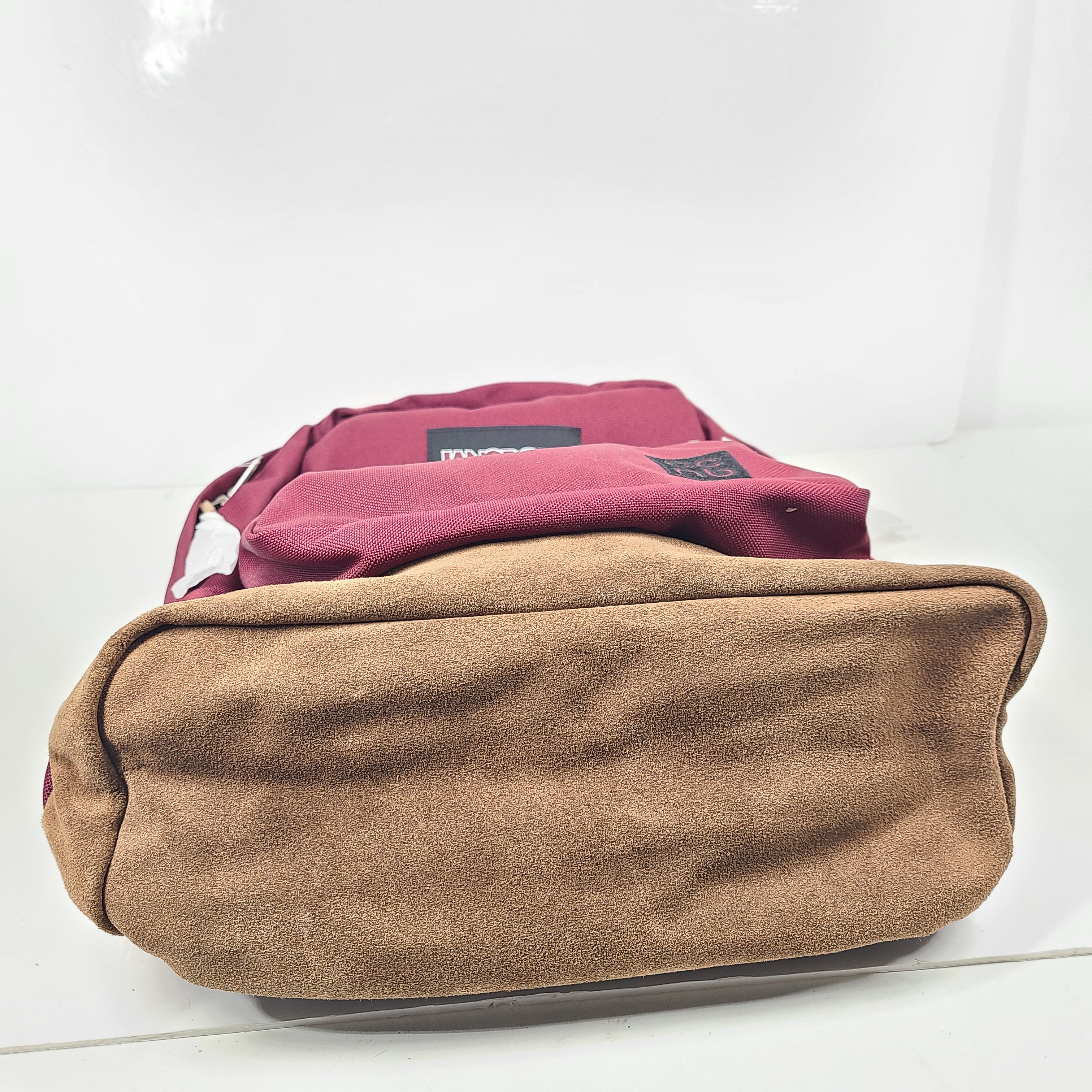 A maroon JanSport backpack with a 15" laptop sleeve.