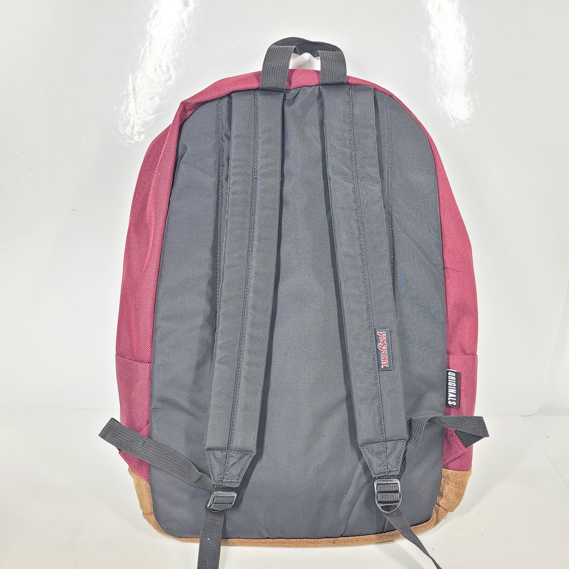 A maroon JanSport backpack with a 15" laptop sleeve.