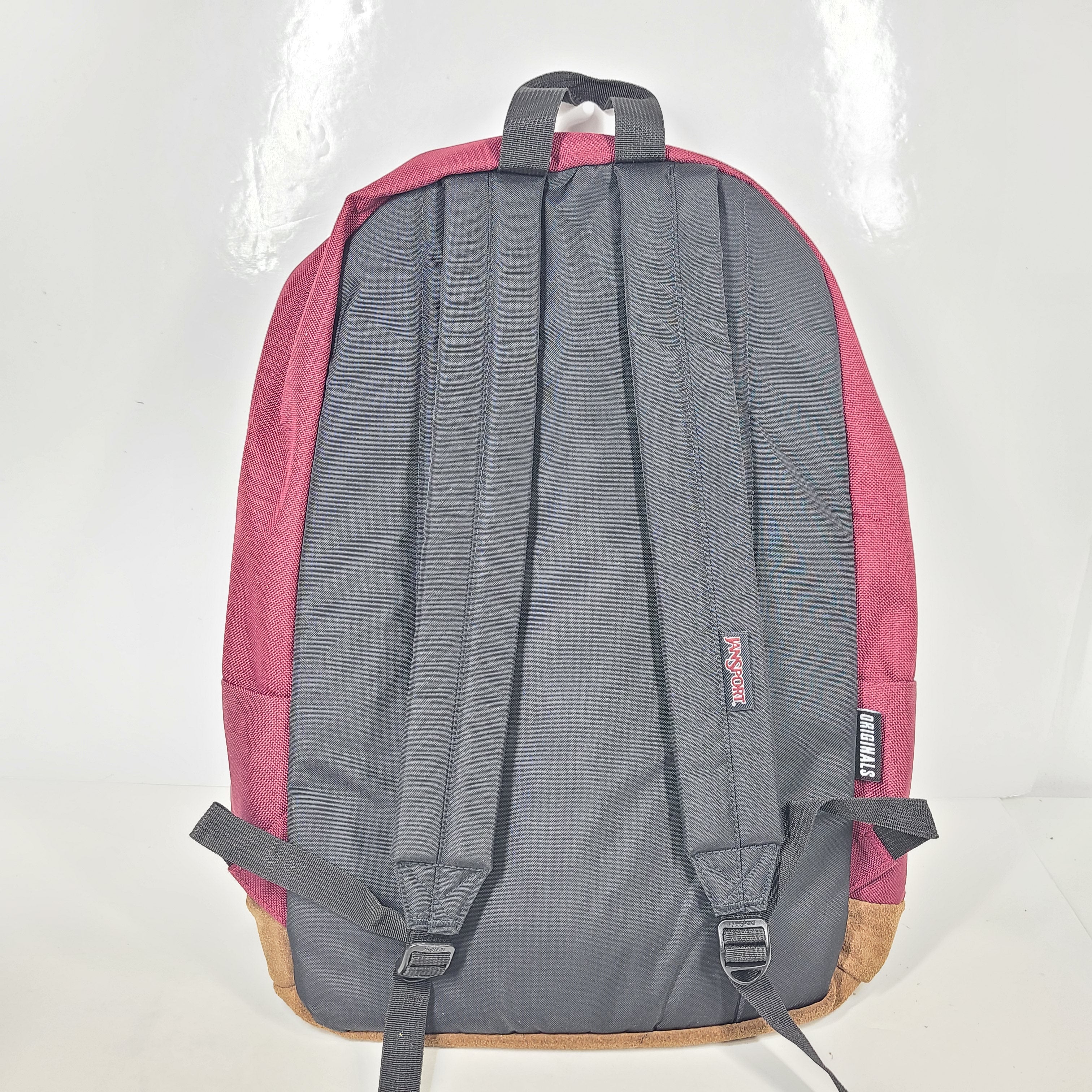 A maroon JanSport backpack with a 15" laptop sleeve.