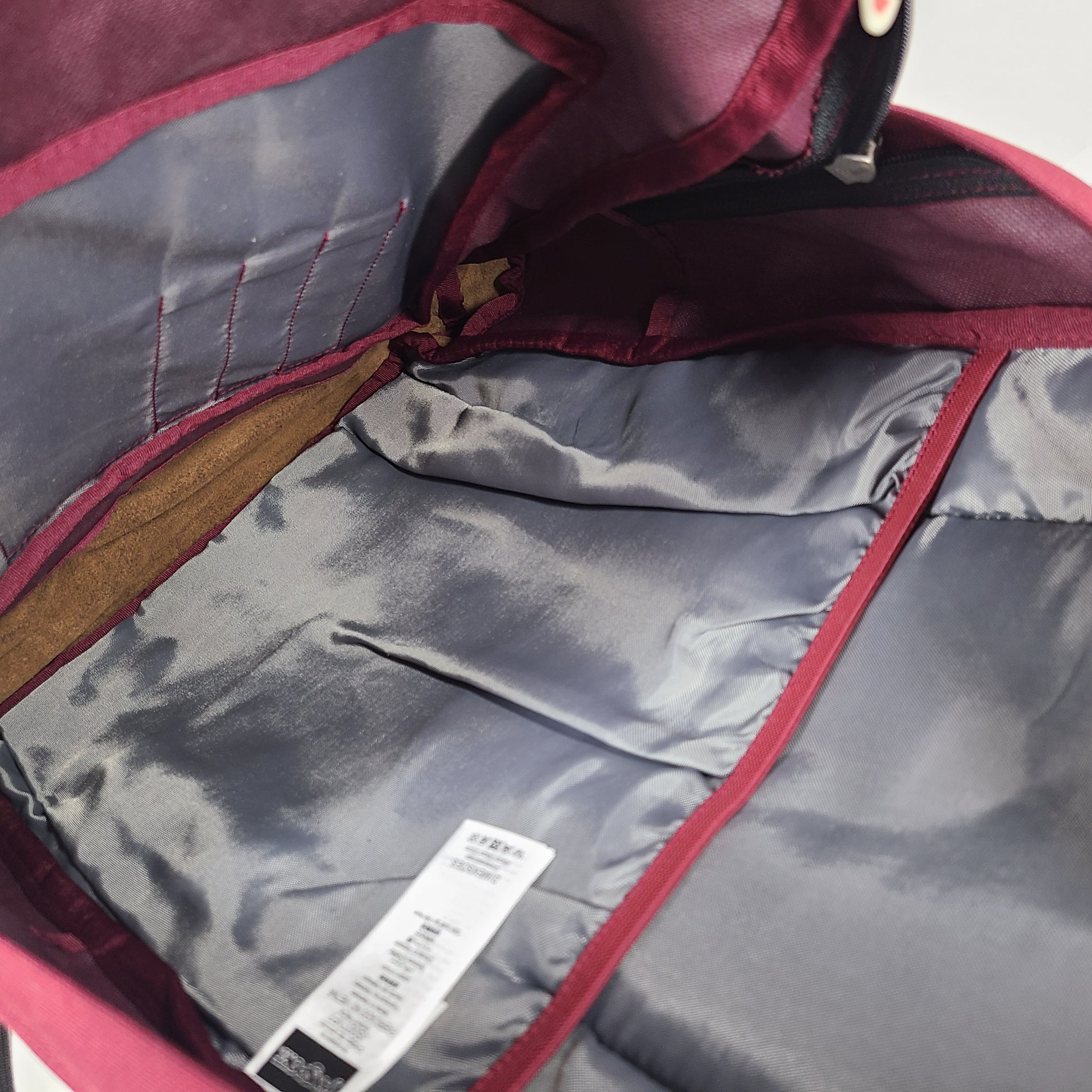 A maroon JanSport backpack with a 15" laptop sleeve.