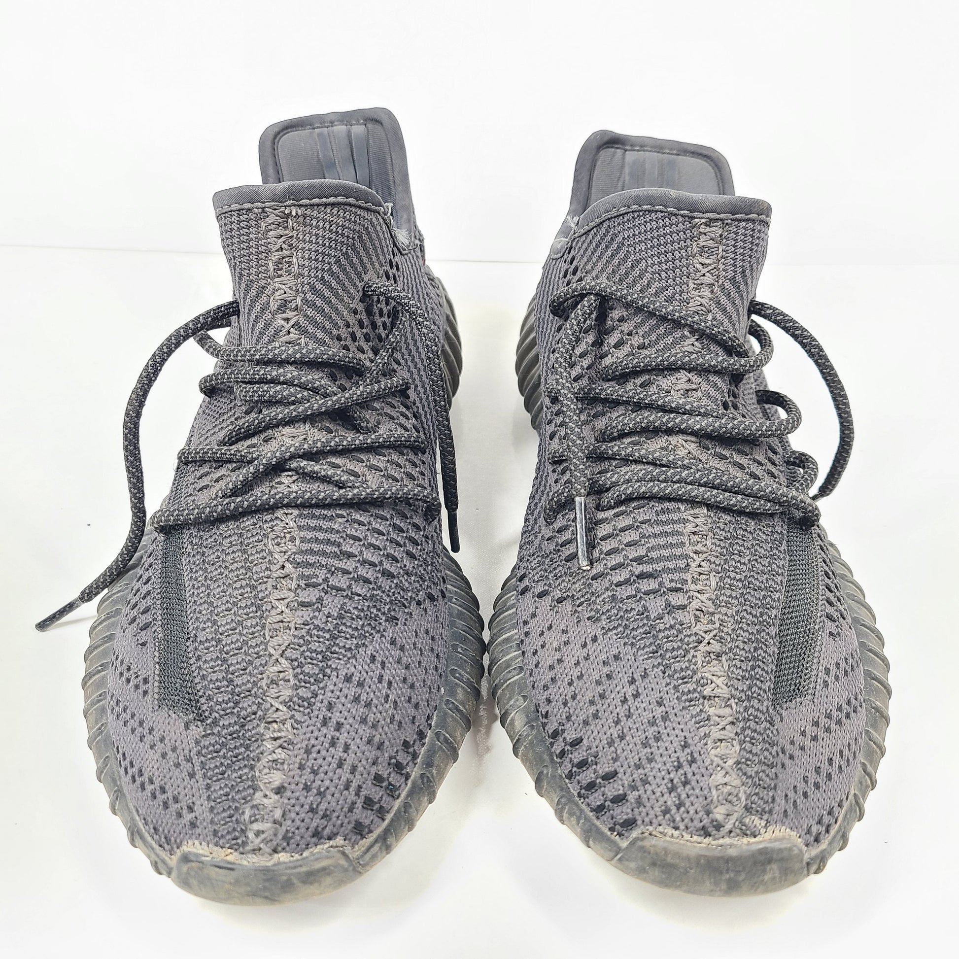 A pair of black and gray Adidas Yeezy Boost 350 V2 sneakers in size 10.5