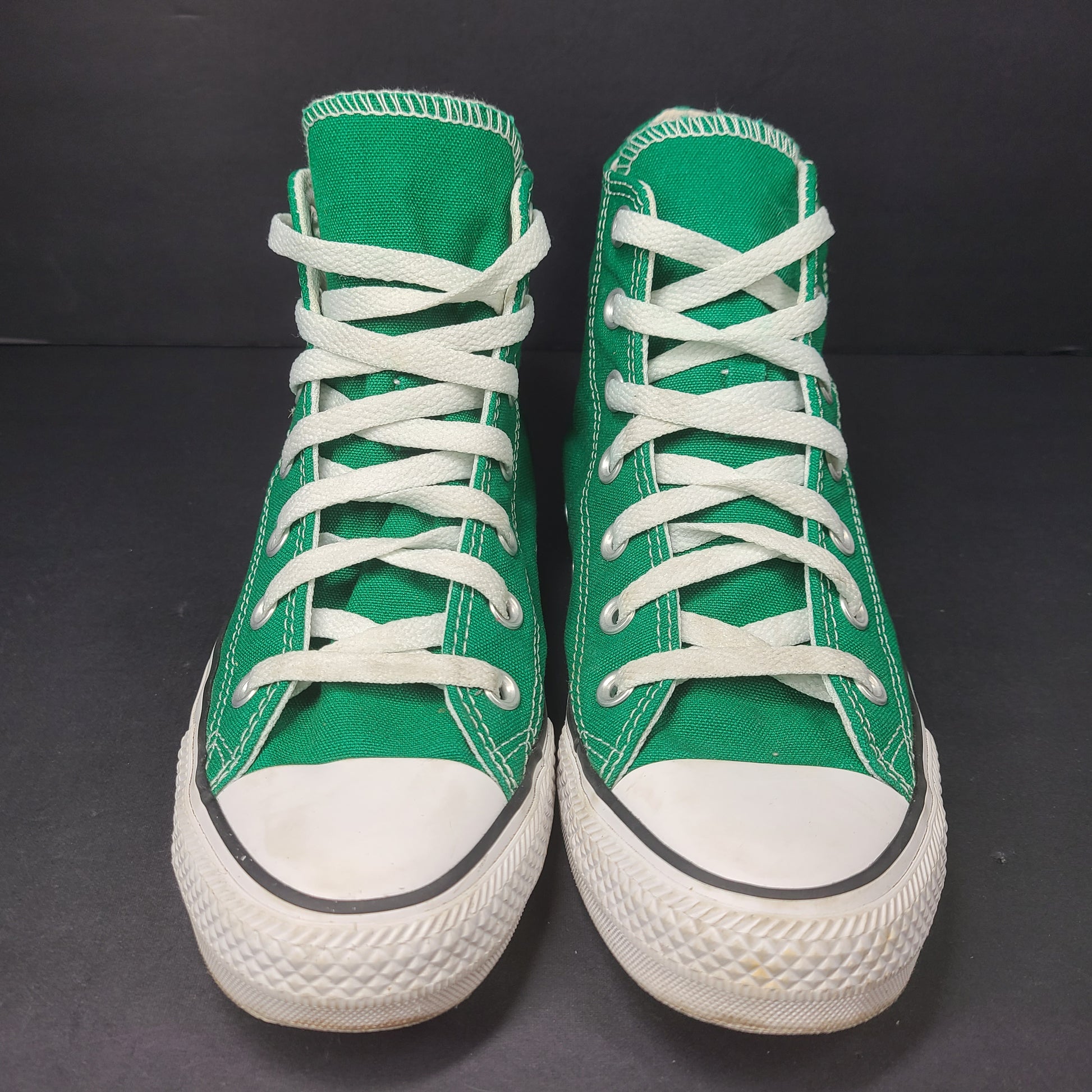 A pair of green Converse All Star high top sneakers for men and women.