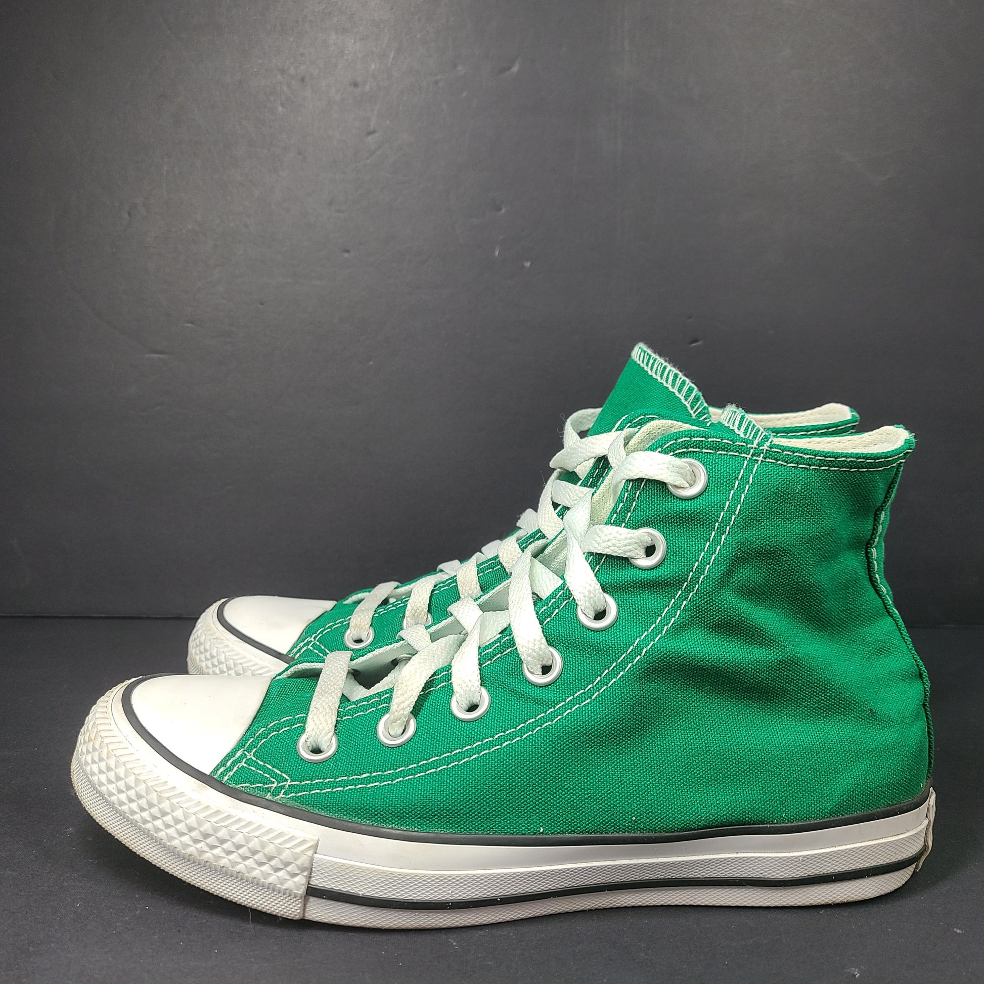 A pair of green Converse All Star high top sneakers for men and women.