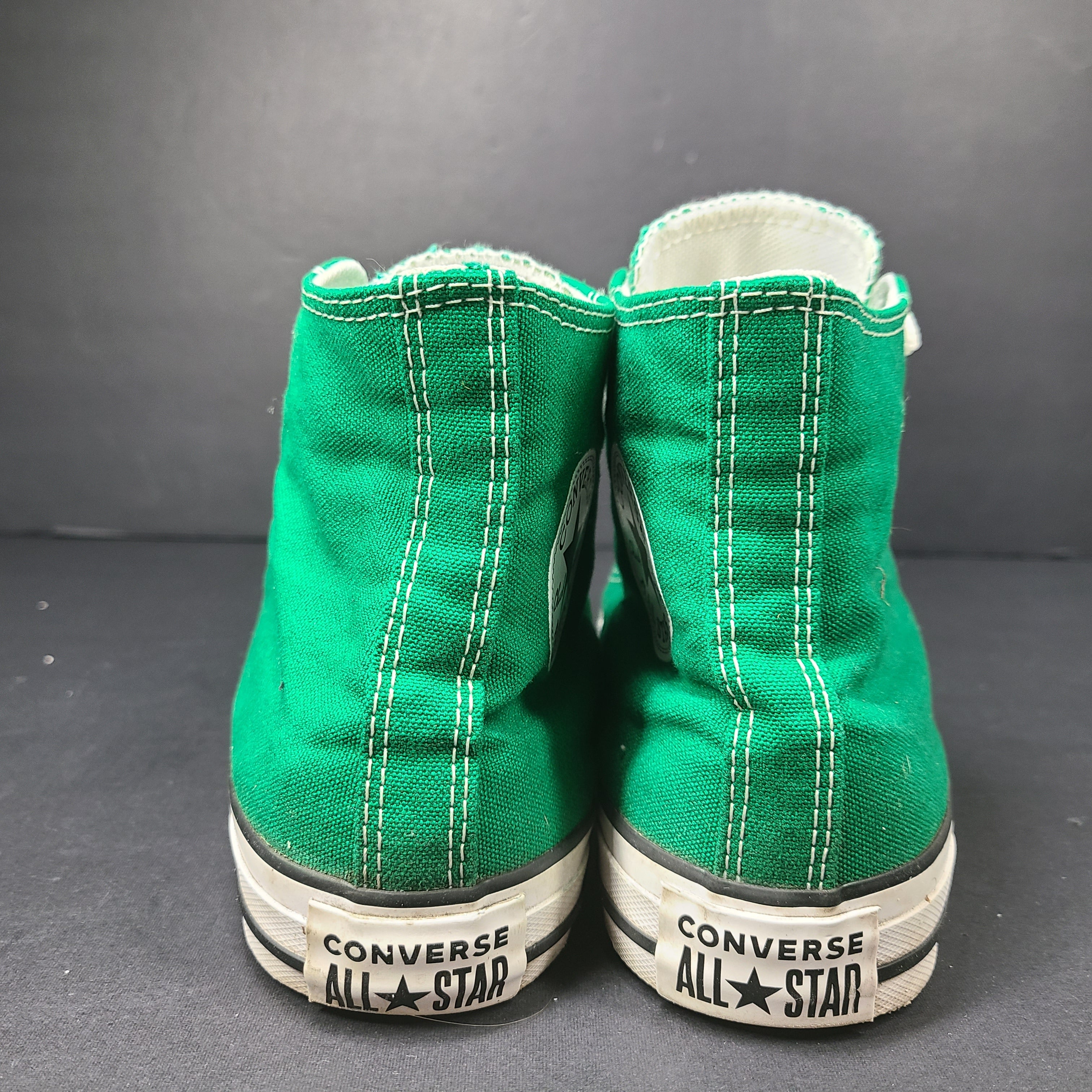 A pair of green Converse All Star high top sneakers for men and women.