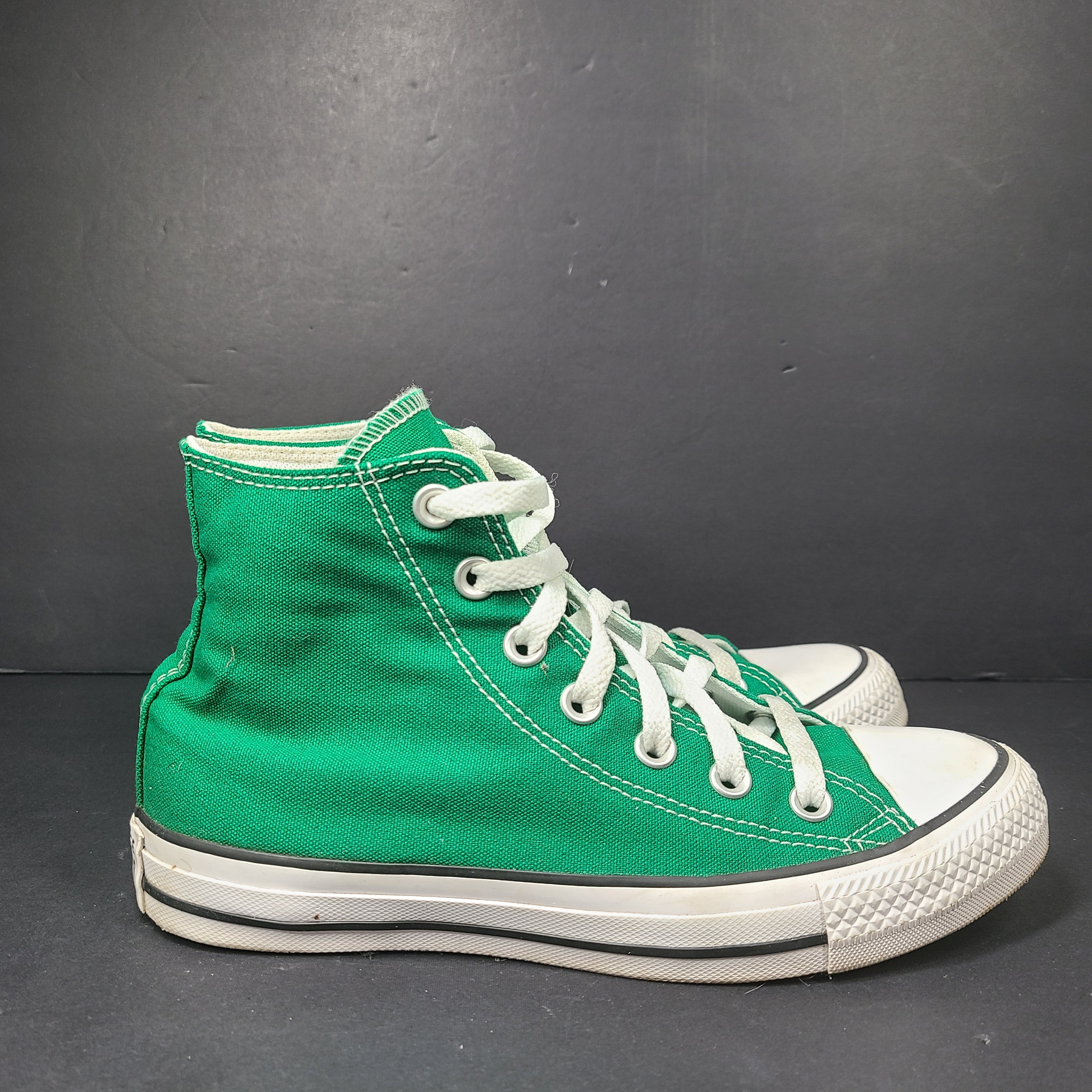 A pair of green Converse All Star high top sneakers for men and women.