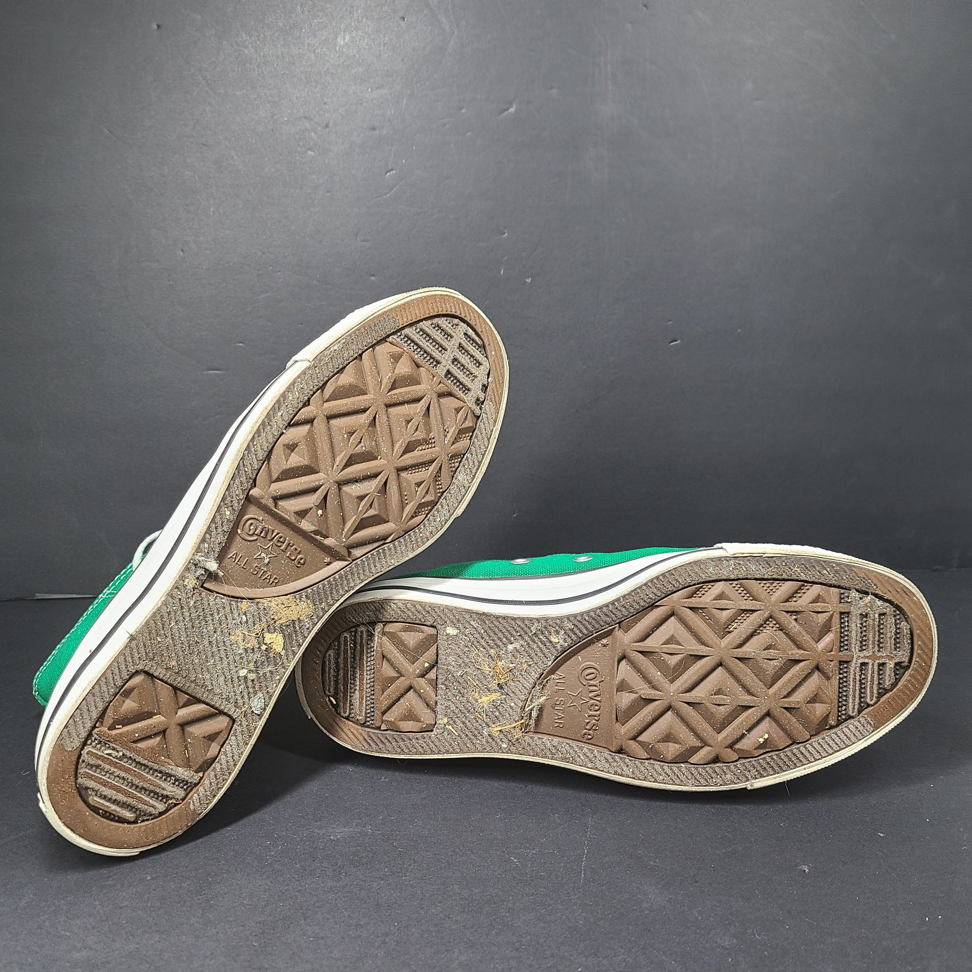 A pair of green Converse All Star high top sneakers for men and women.