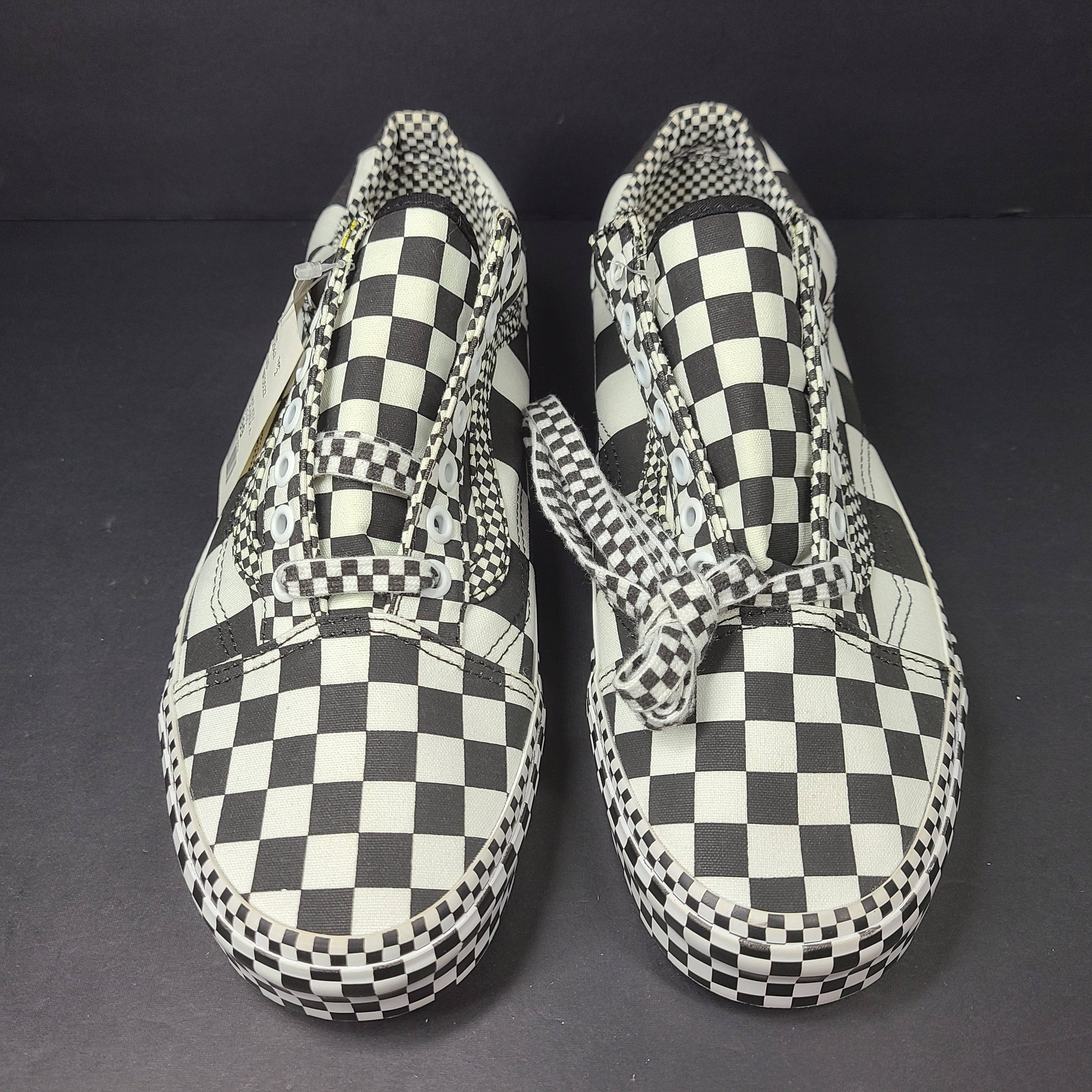 A pair of Vans checkerboard sneakers in men's size 9.0 and women's size 10.5