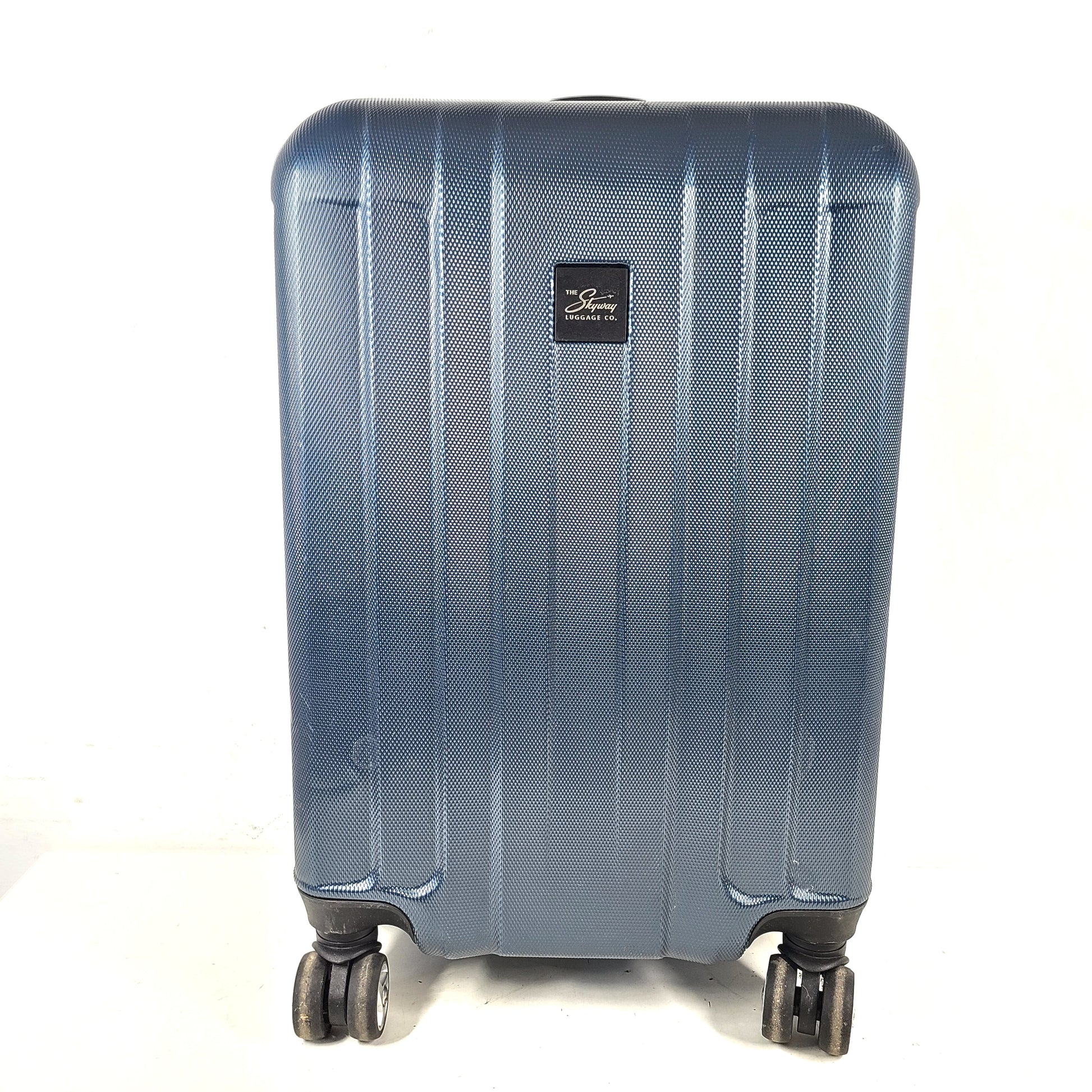 A blue hard shell suitcase by Skyway Luggage Co.