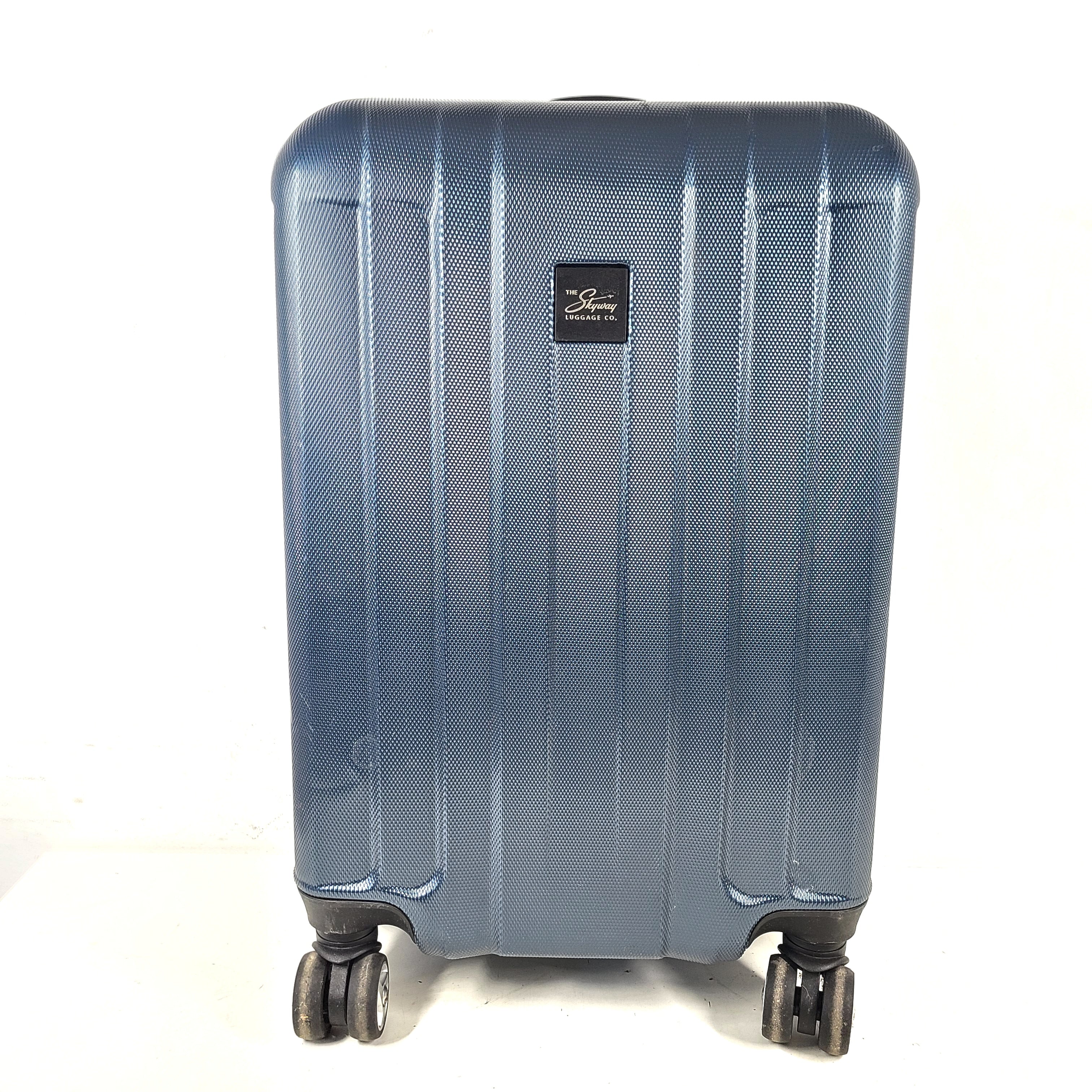 A blue hard shell suitcase by Skyway Luggage Co.