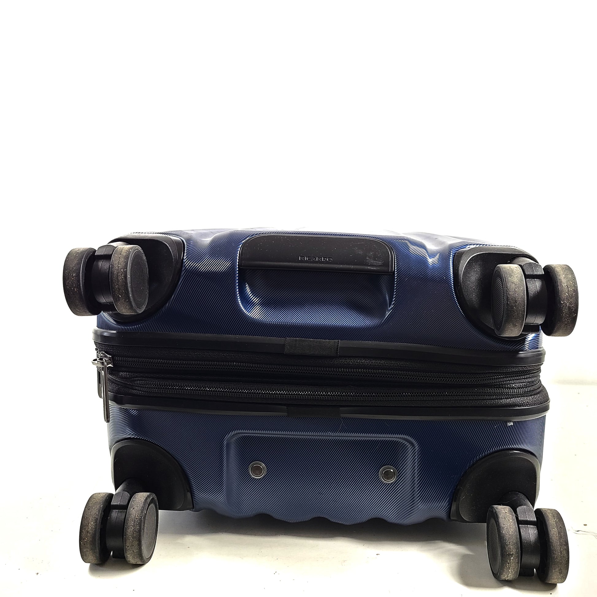 A sleek blue spinner luggage by Ricardo Beverly Hills.