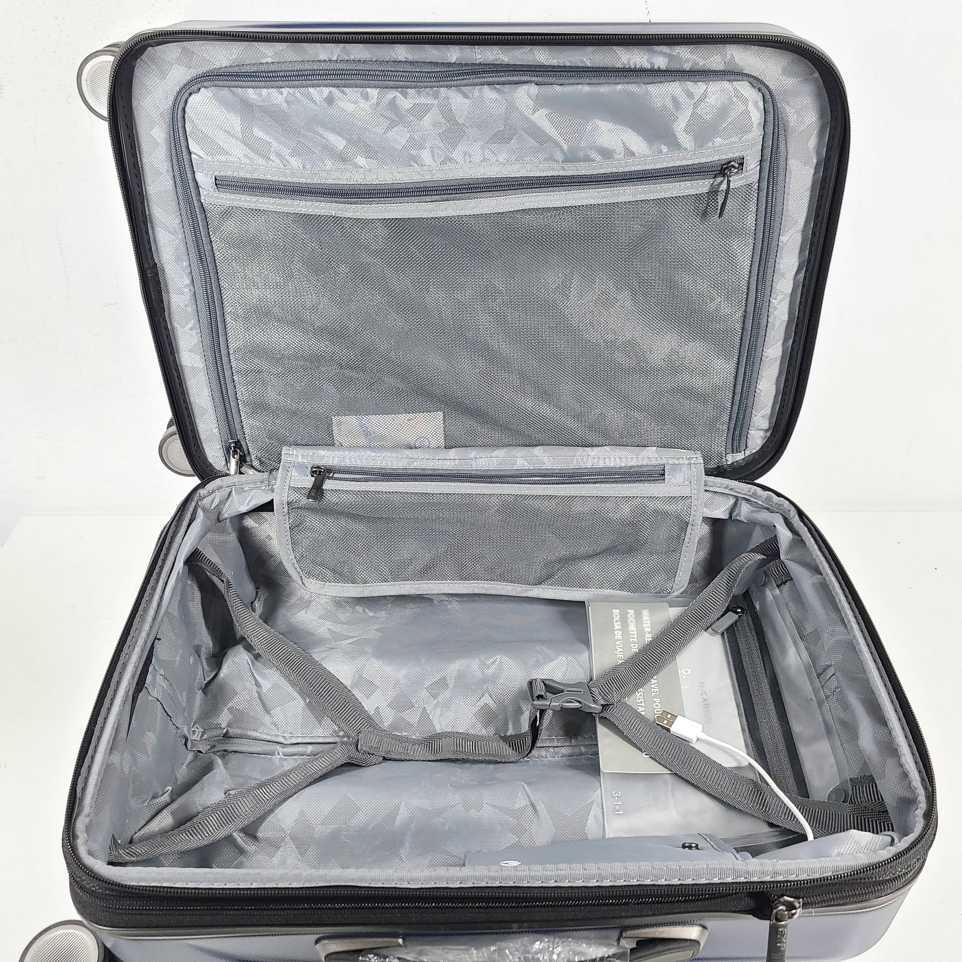A sleek blue spinner luggage by Ricardo Beverly Hills.