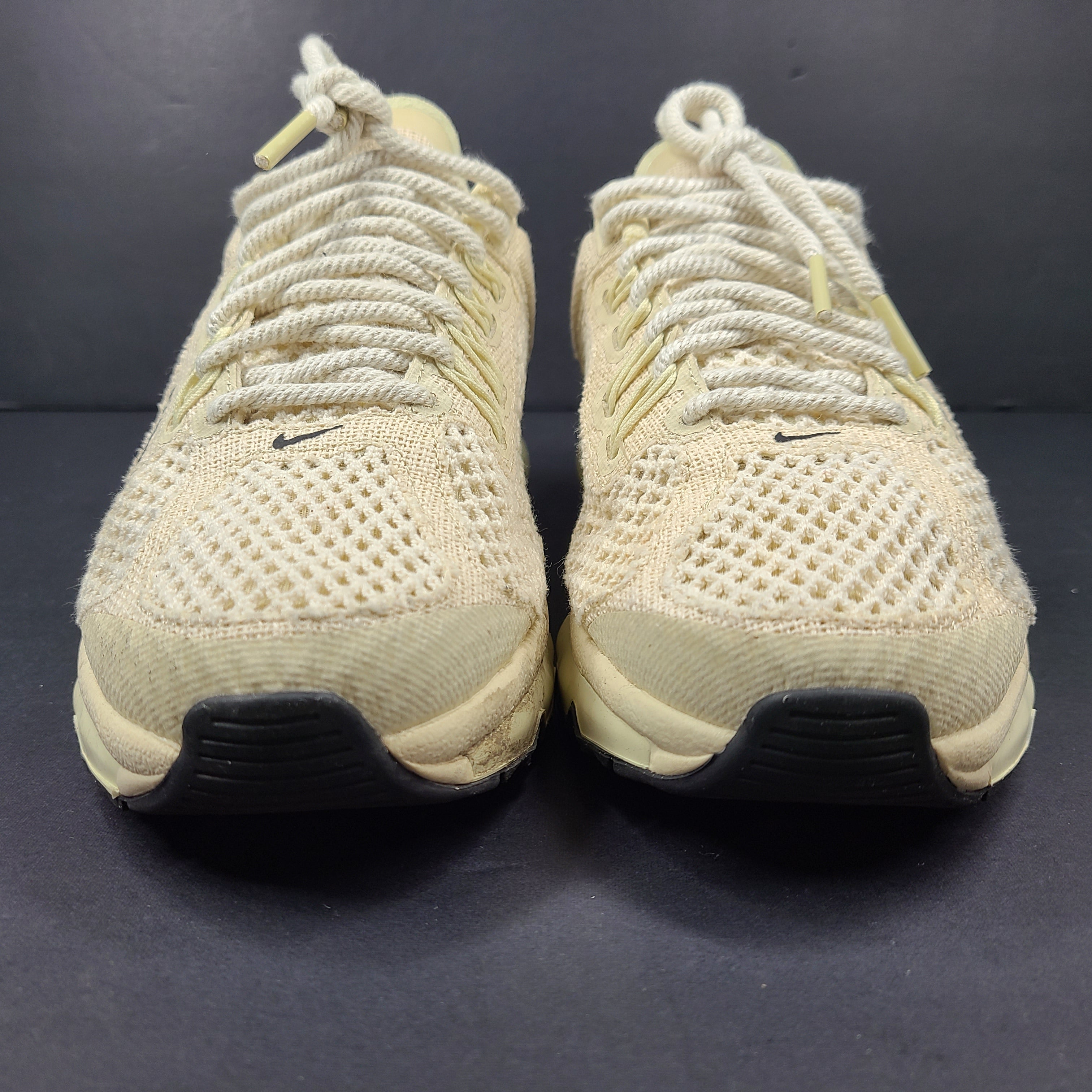 A pair of beige Nike x Stussy Air Max sneakers