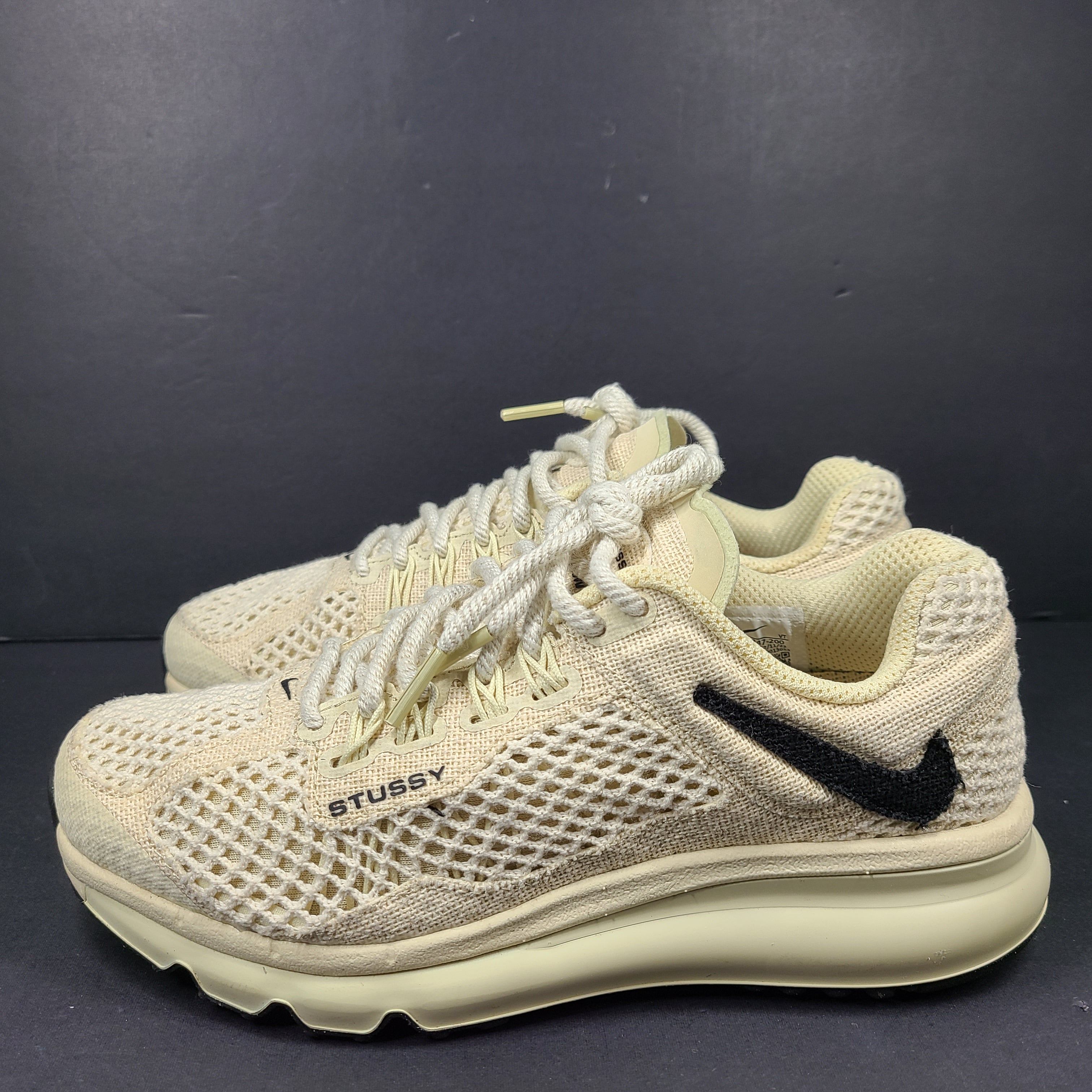 A pair of beige Nike x Stussy Air Max sneakers
