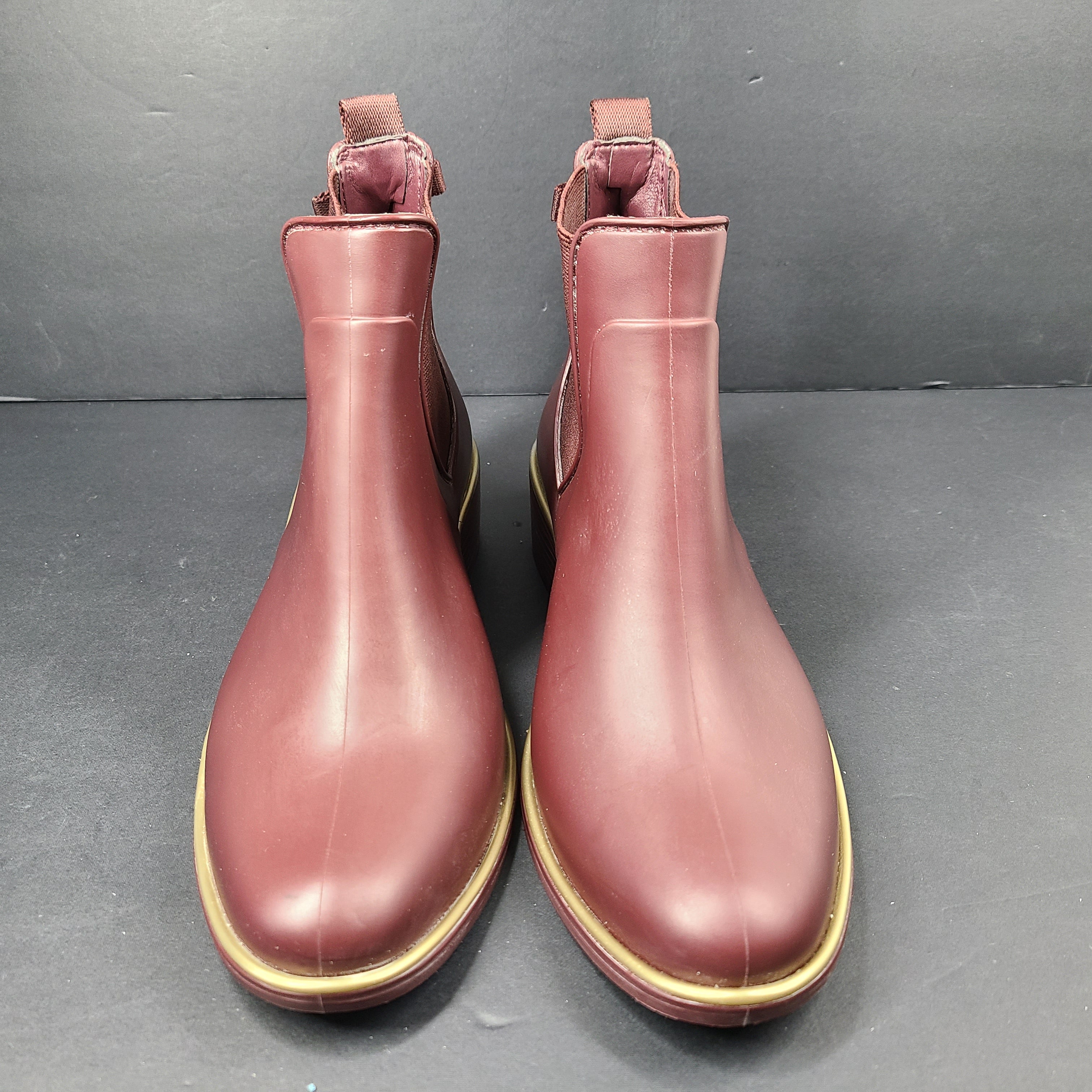 A stylish pair of Kate Spade Chelsea Ankle Boots in burgundy color