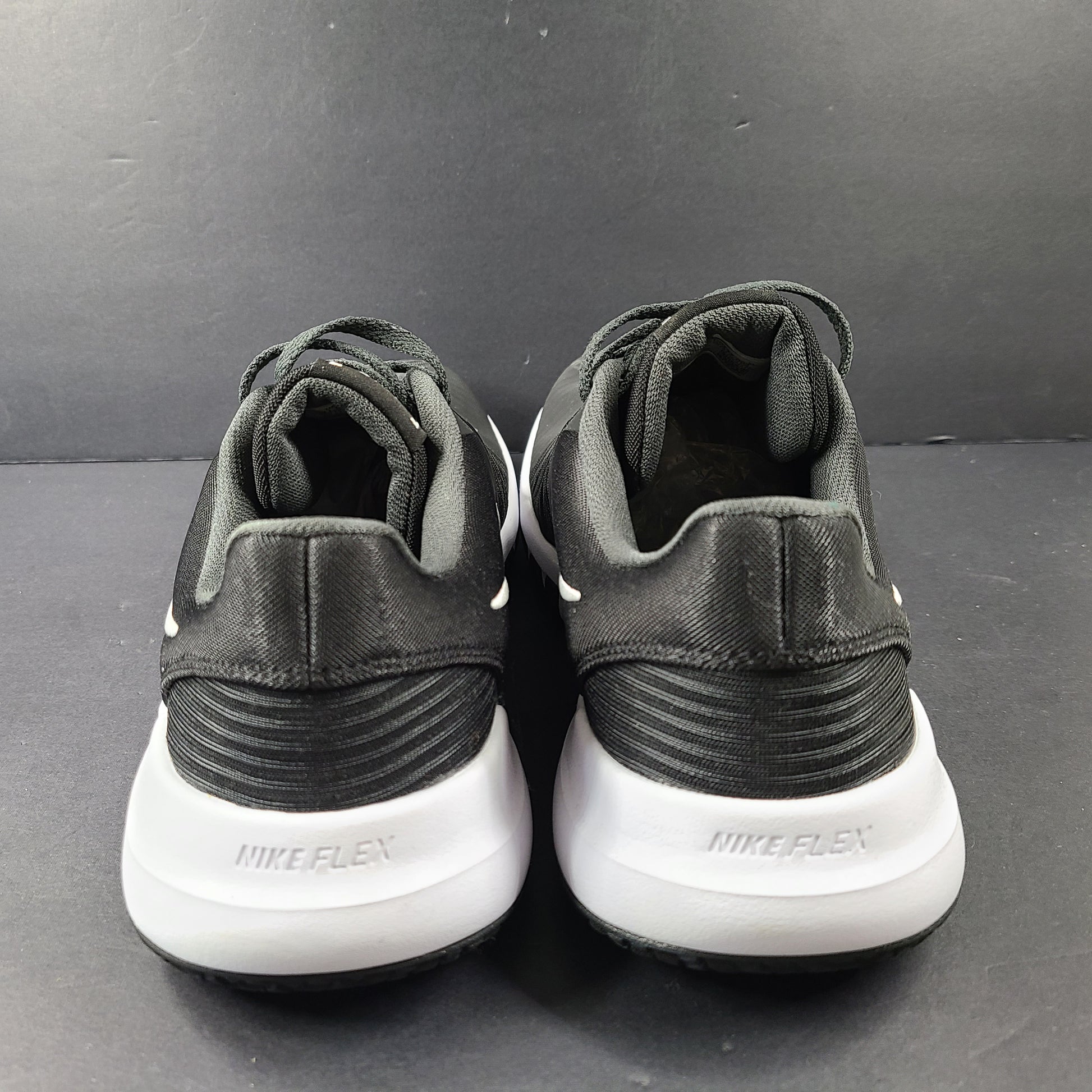 A pair of Nike Flex Training Shoes in Black and White
