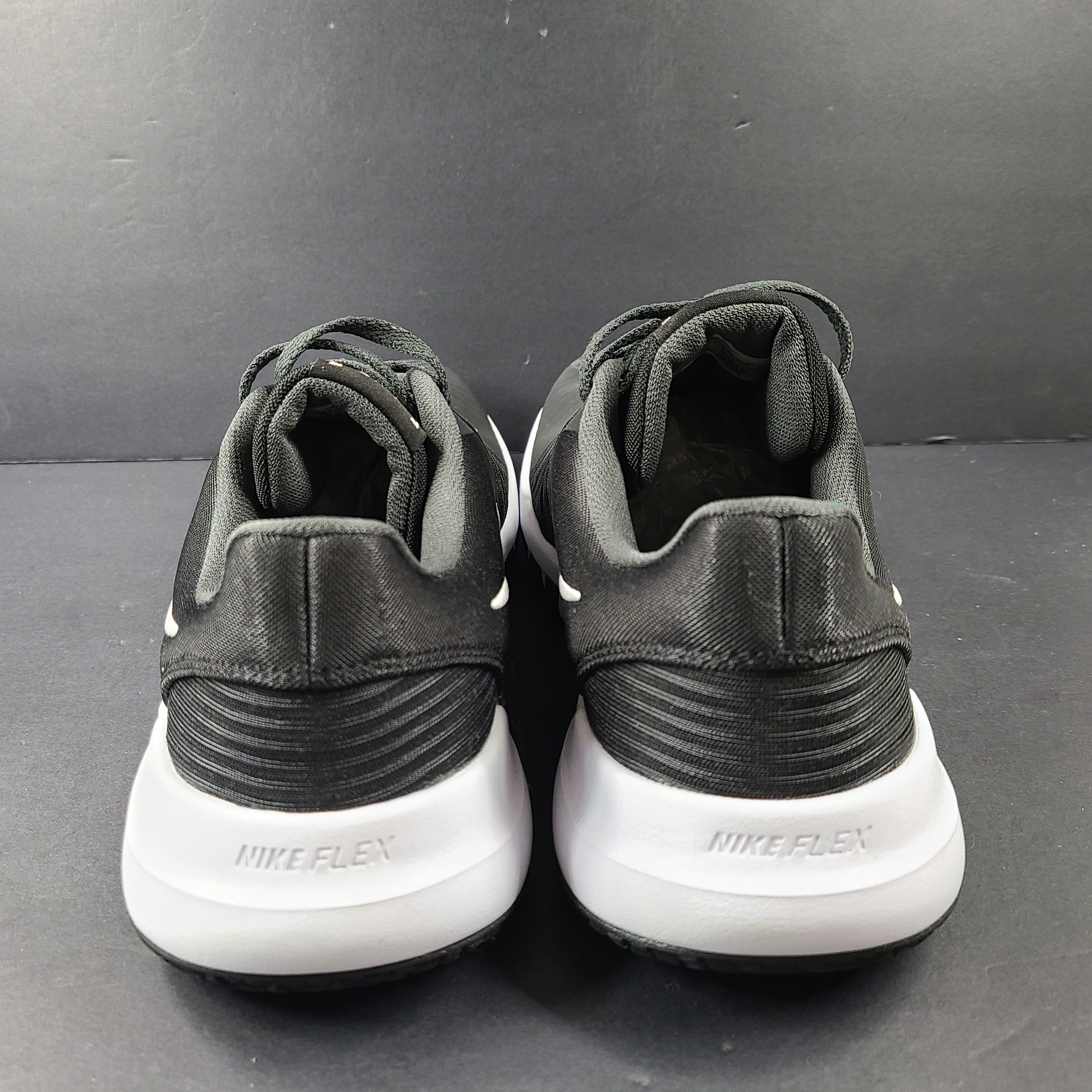 A pair of Nike Flex Training Shoes in Black and White