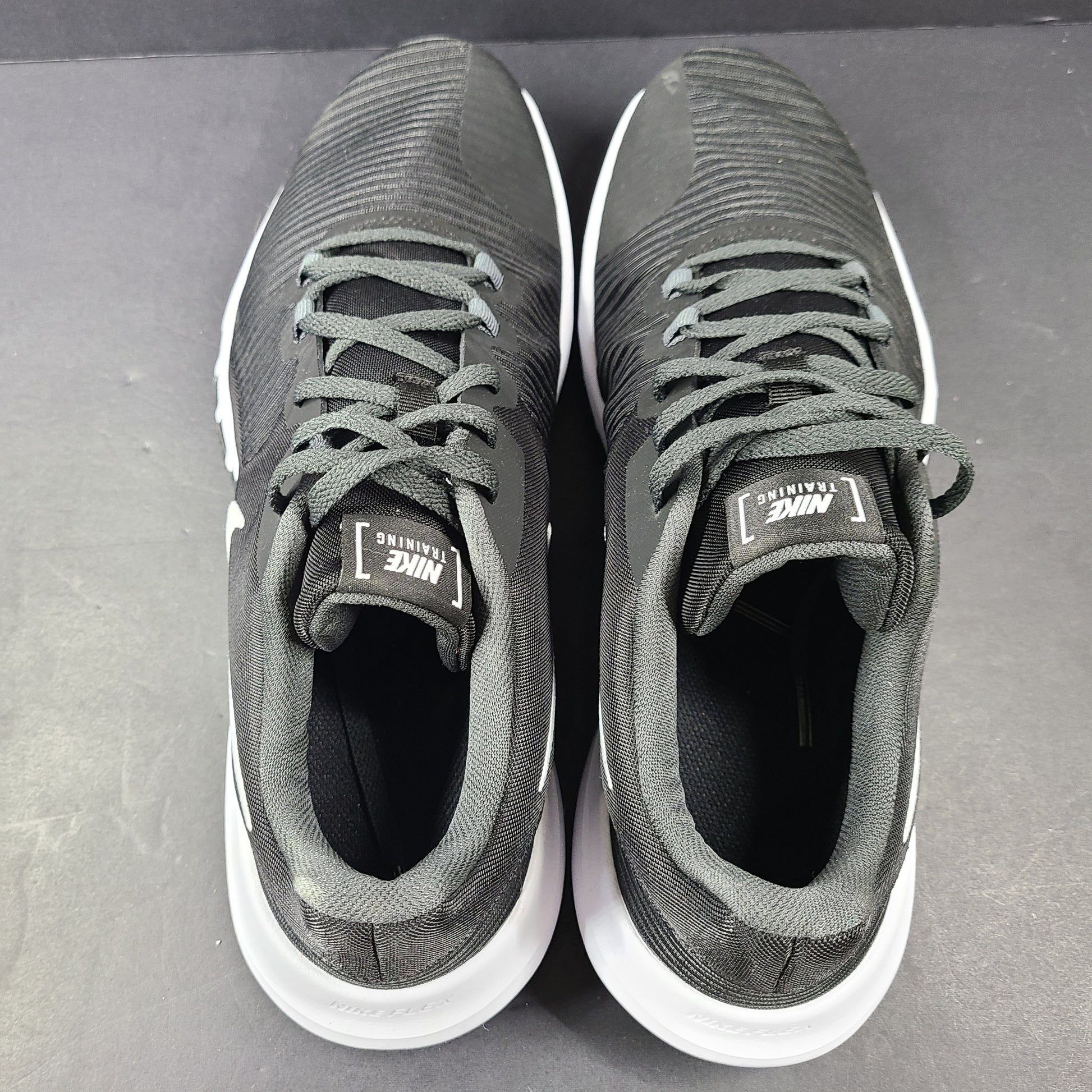 A pair of Nike Flex Training Shoes in Black and White