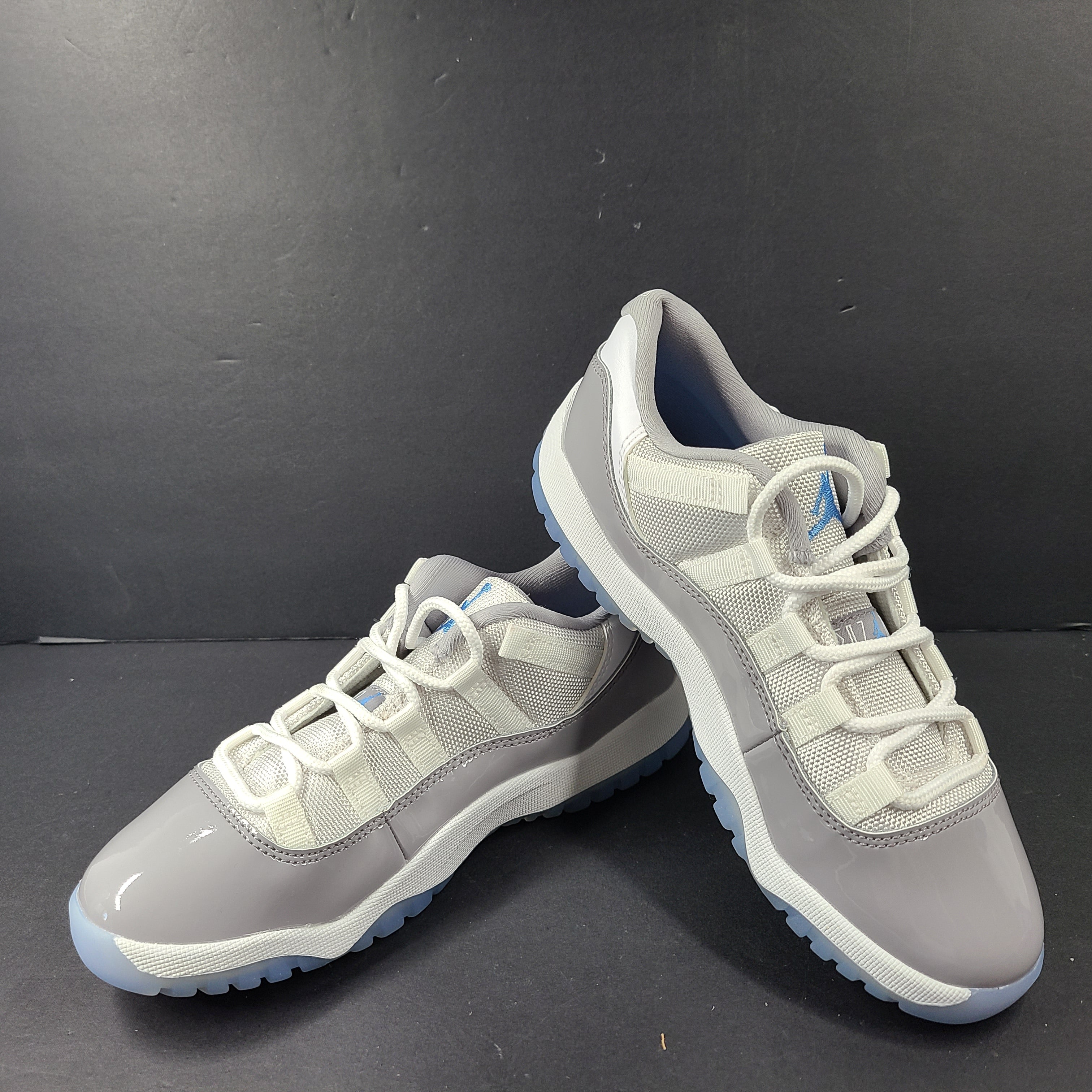 A pair of Nike Air Jordan 11 Retro Low Gray Blue Youth Size 3Y sneakers.