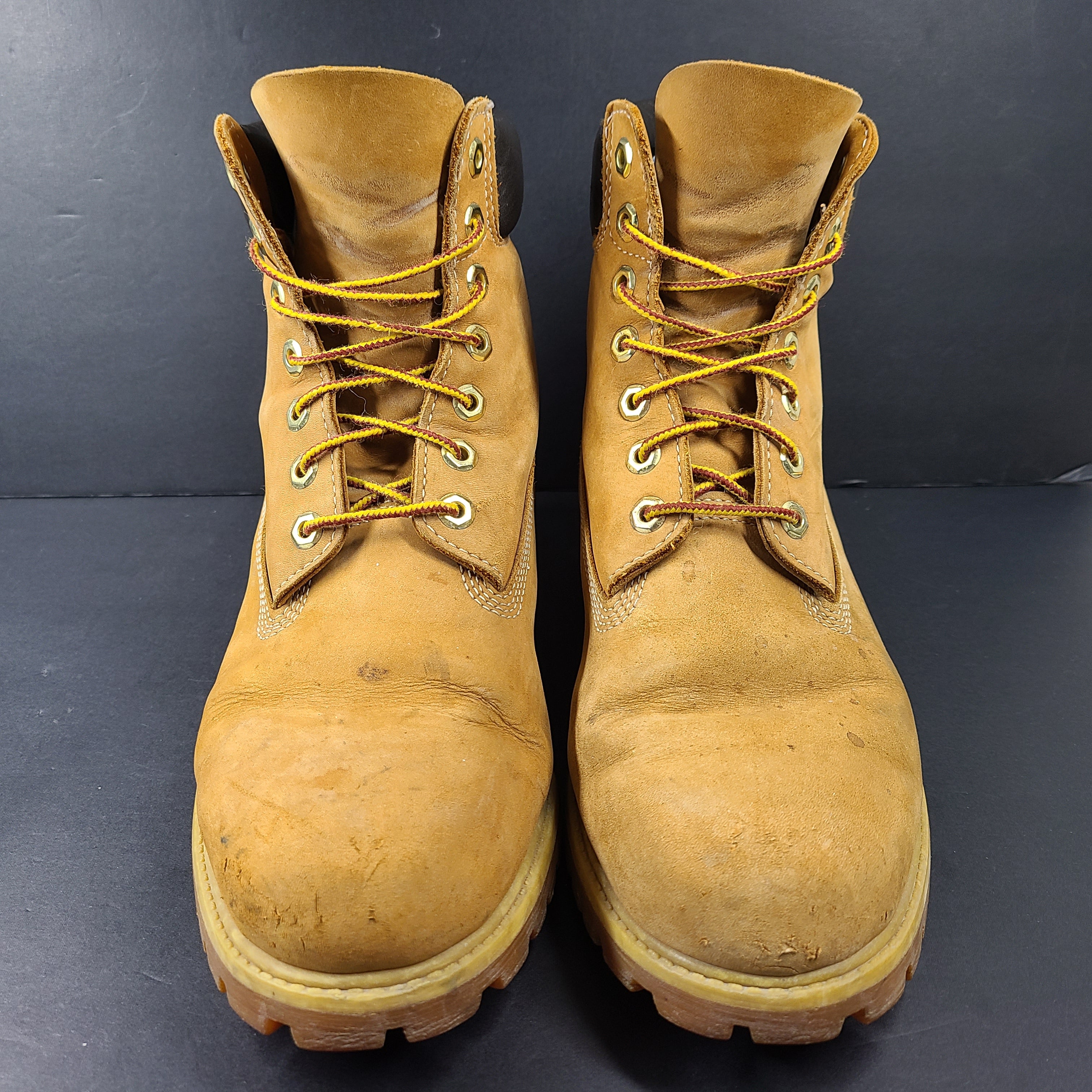 A pair of rugged Timberland men's leather boots in wheat/brown color