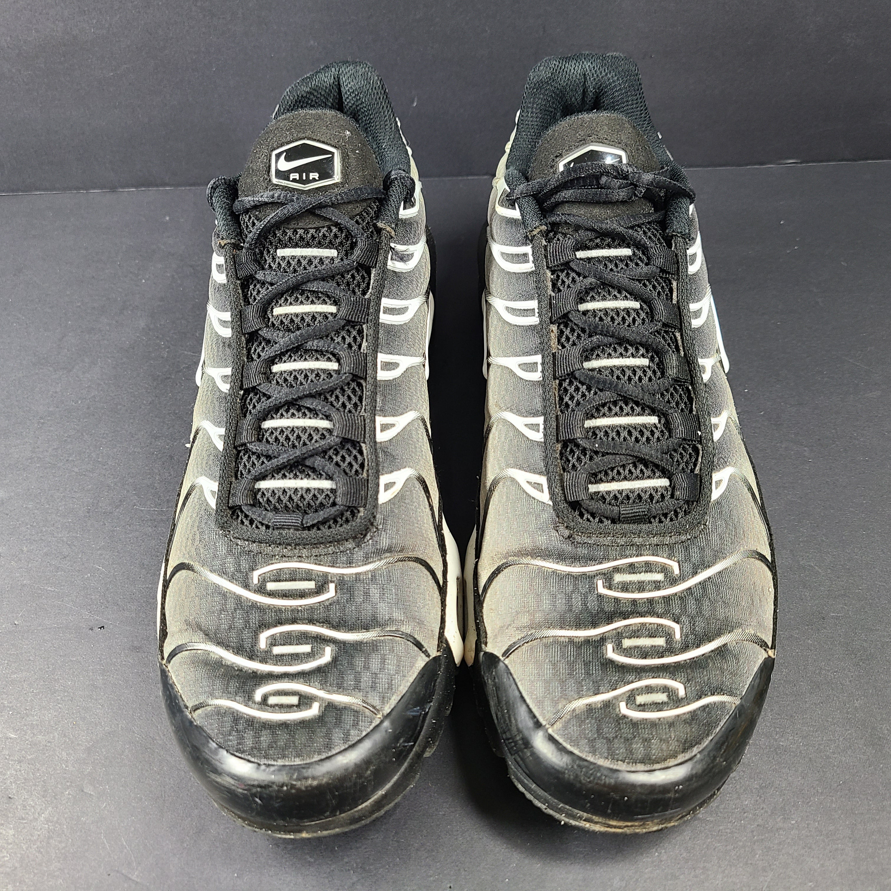 A pair of stylish Nike Air Max Plus Tn DM0032-003 Black/White Men's Shoes Size 8.5