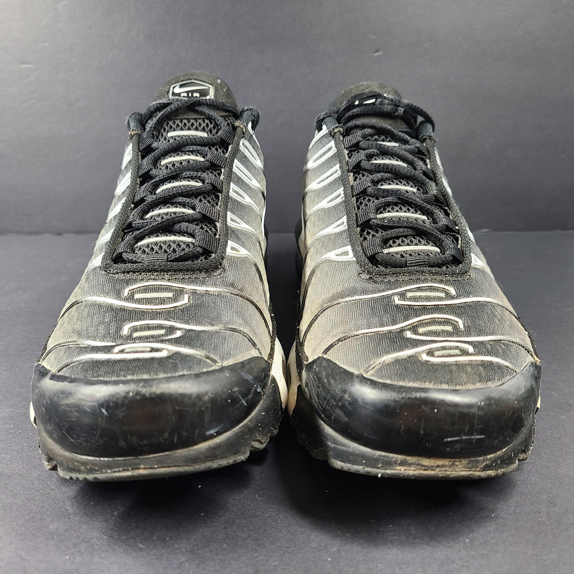 A pair of stylish Nike Air Max Plus Tn DM0032-003 Black/White Men's Shoes Size 8.5
