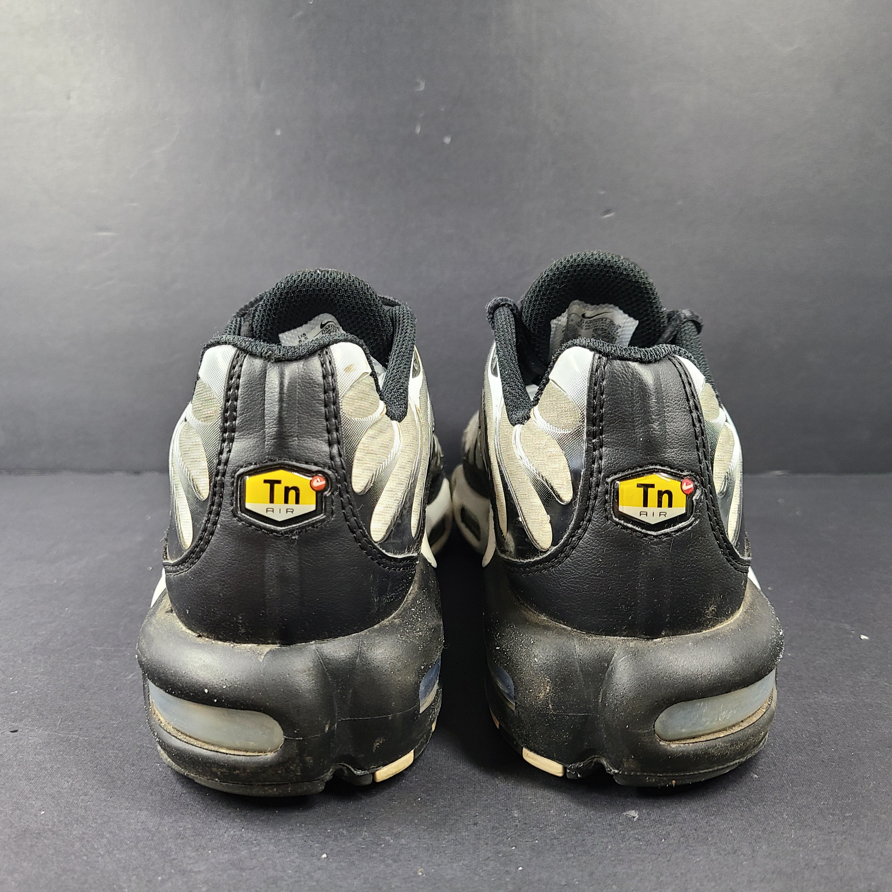 A pair of stylish Nike Air Max Plus Tn DM0032-003 Black/White Men's Shoes Size 8.5