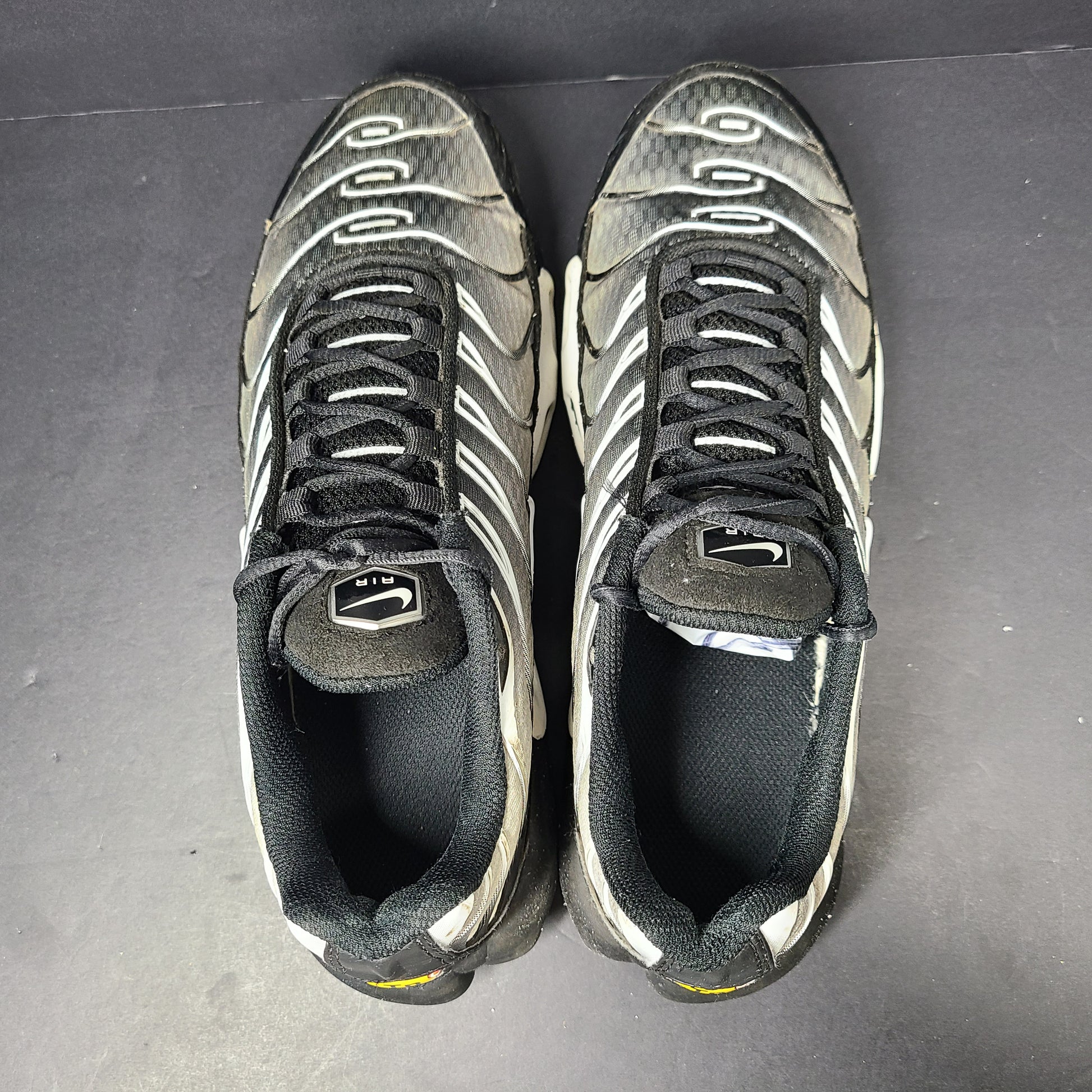 A pair of stylish Nike Air Max Plus Tn DM0032-003 Black/White Men's Shoes Size 8.5