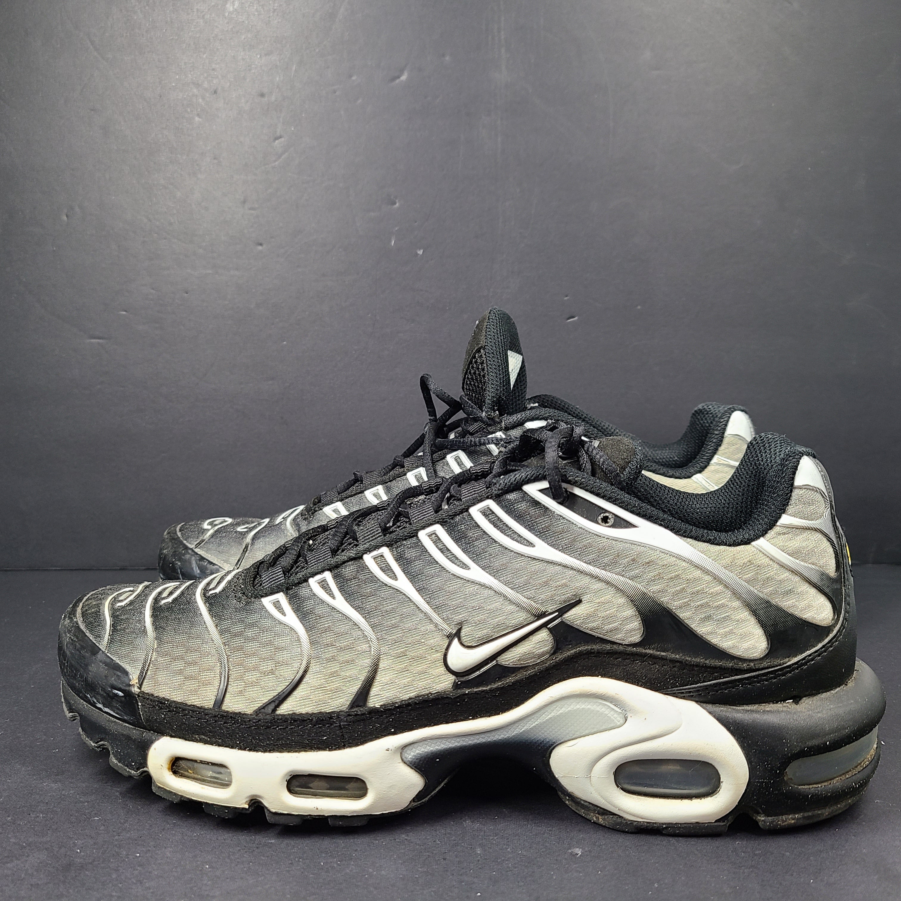A pair of stylish Nike Air Max Plus Tn DM0032-003 Black/White Men's Shoes Size 8.5