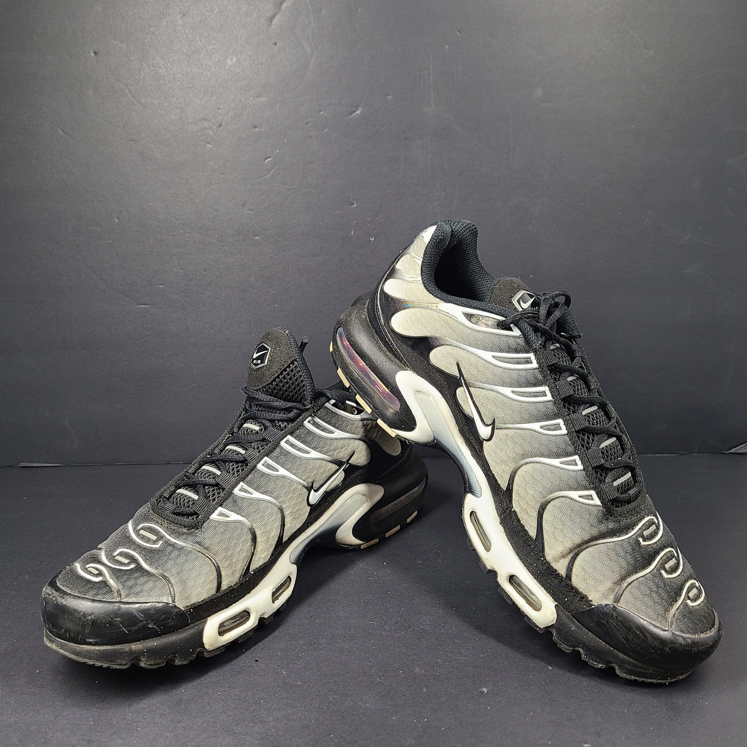 A pair of stylish Nike Air Max Plus Tn DM0032-003 Black/White Men's Shoes Size 8.5
