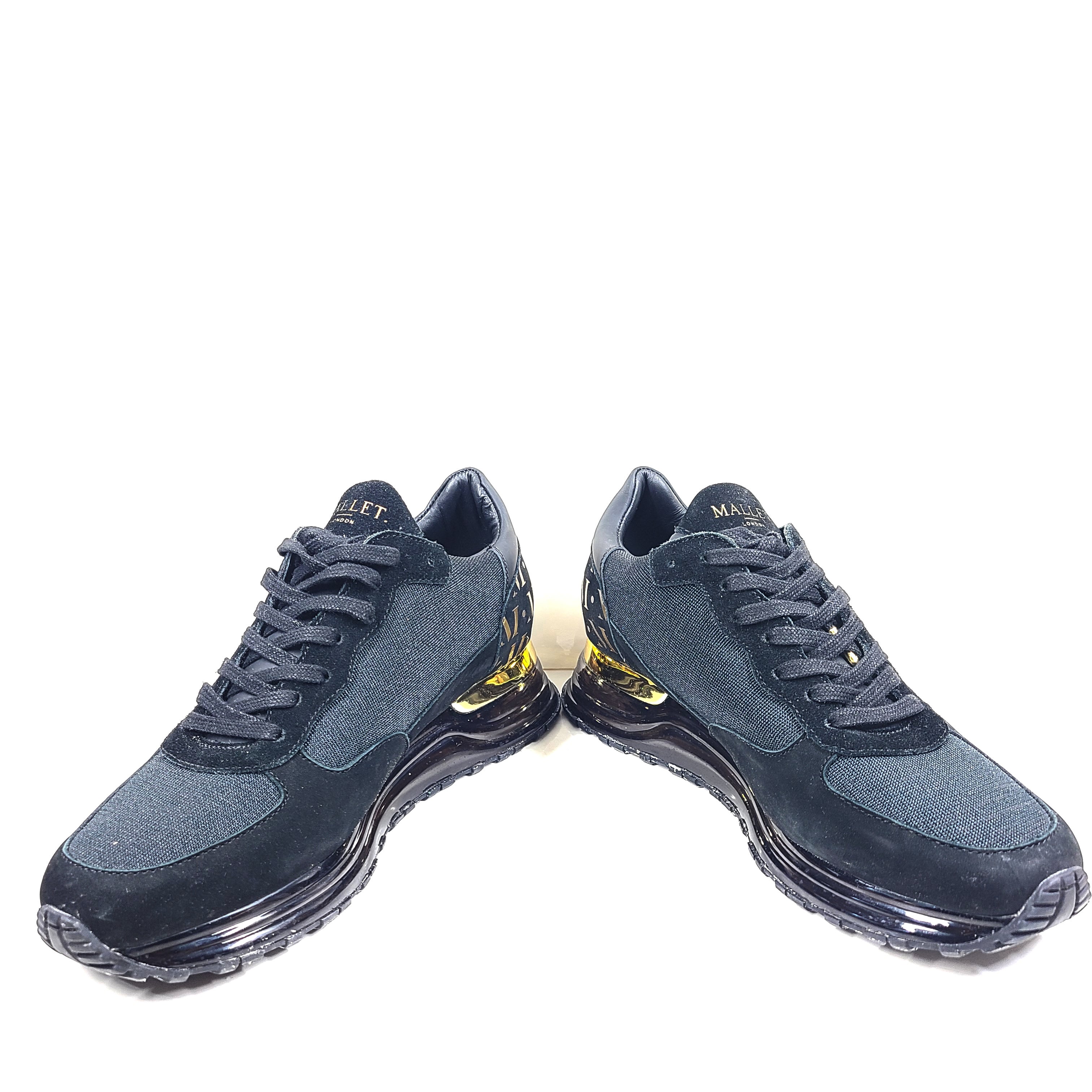A pair of sleek black and gold Mallet London sneakers
