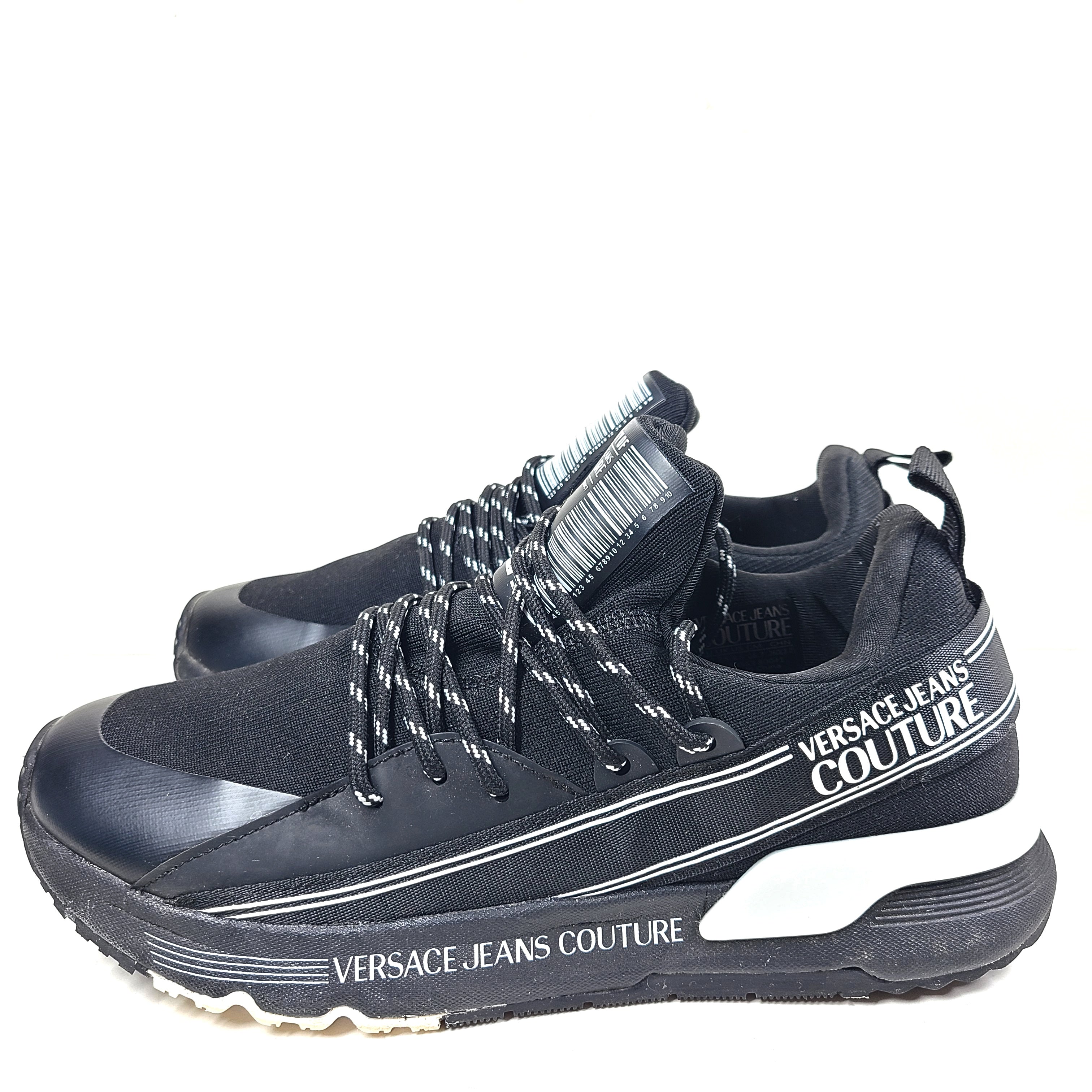 A pair of Versace Jeans Couture black sneakers with slight wear.