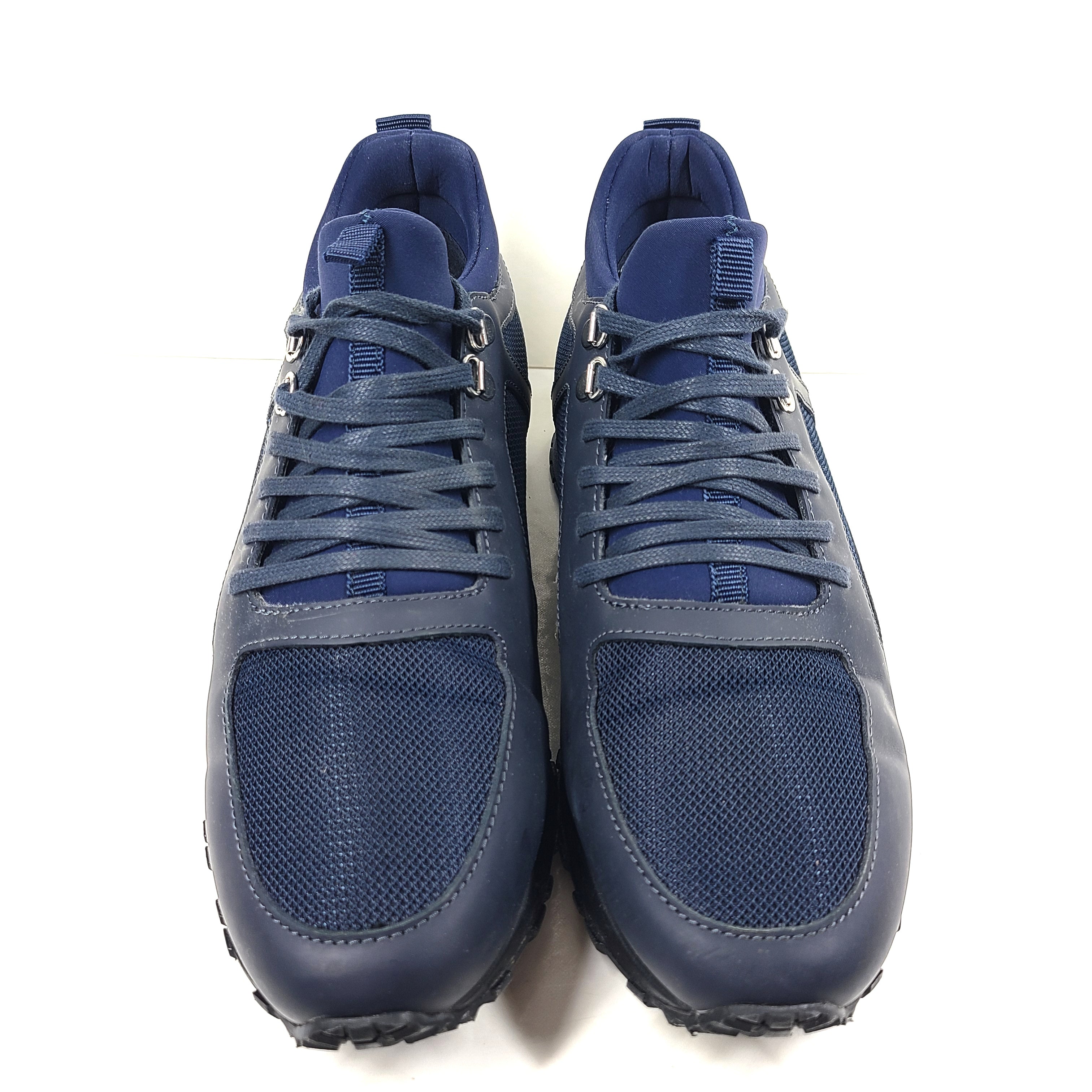 A pair of navy blue mesh and leather sneakers by Mallet.