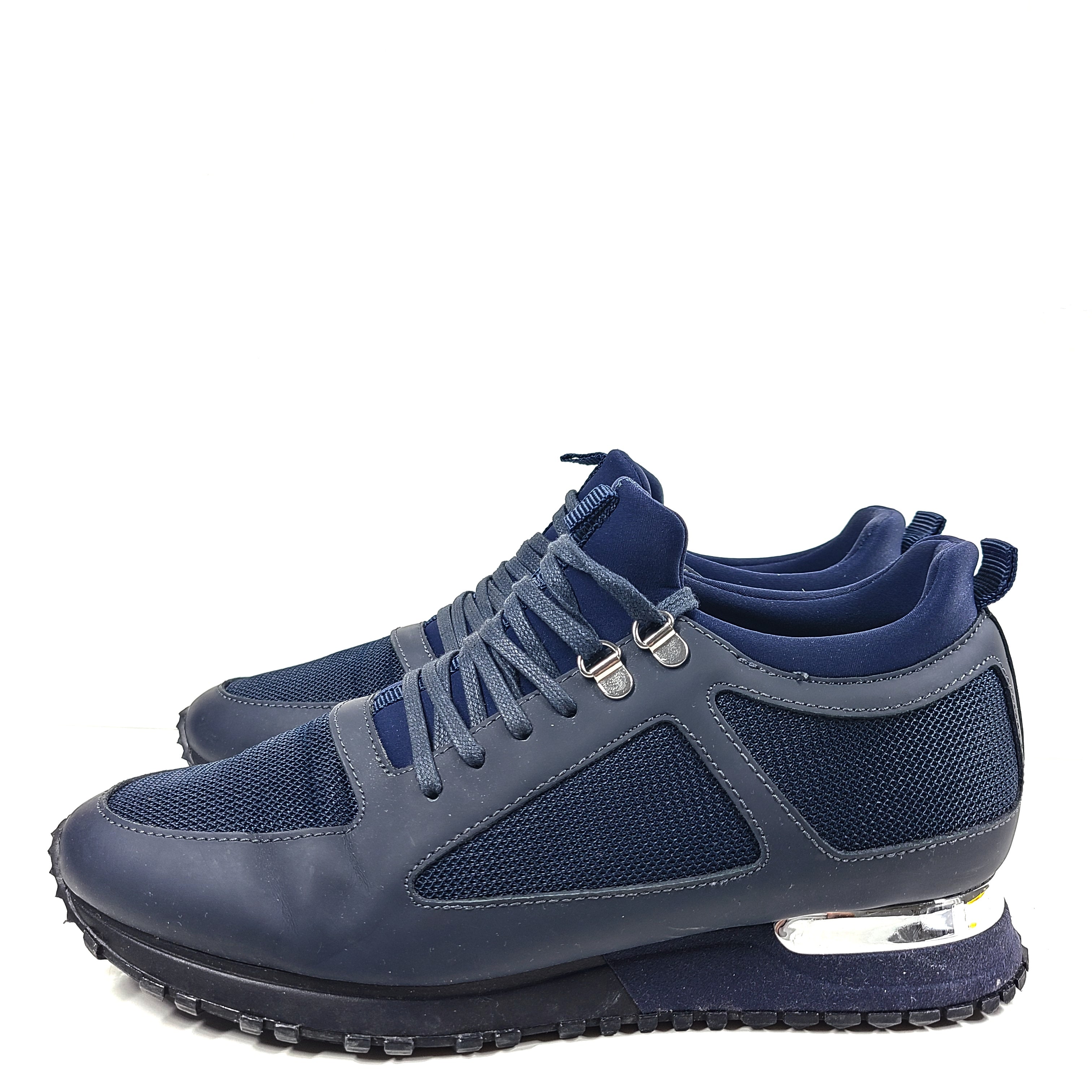 A pair of navy blue mesh and leather sneakers by Mallet.