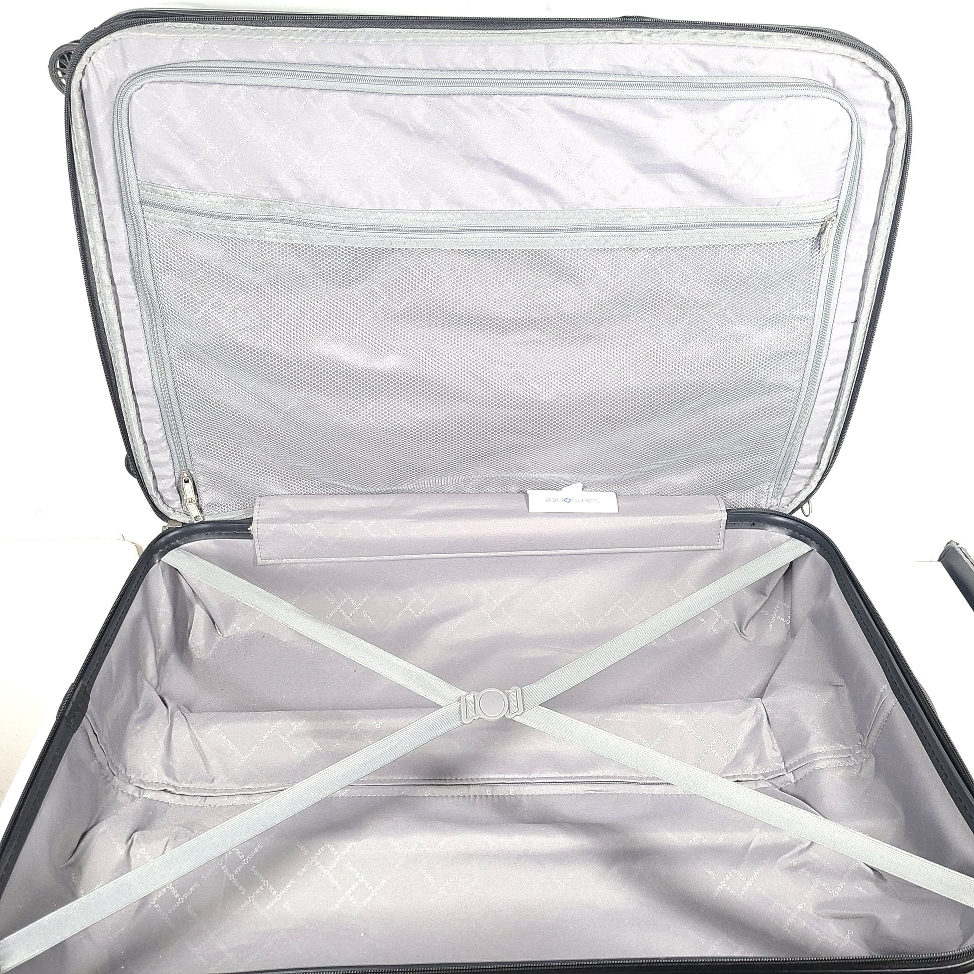 A silver hard shell Samsonite 4-wheel suitcase.