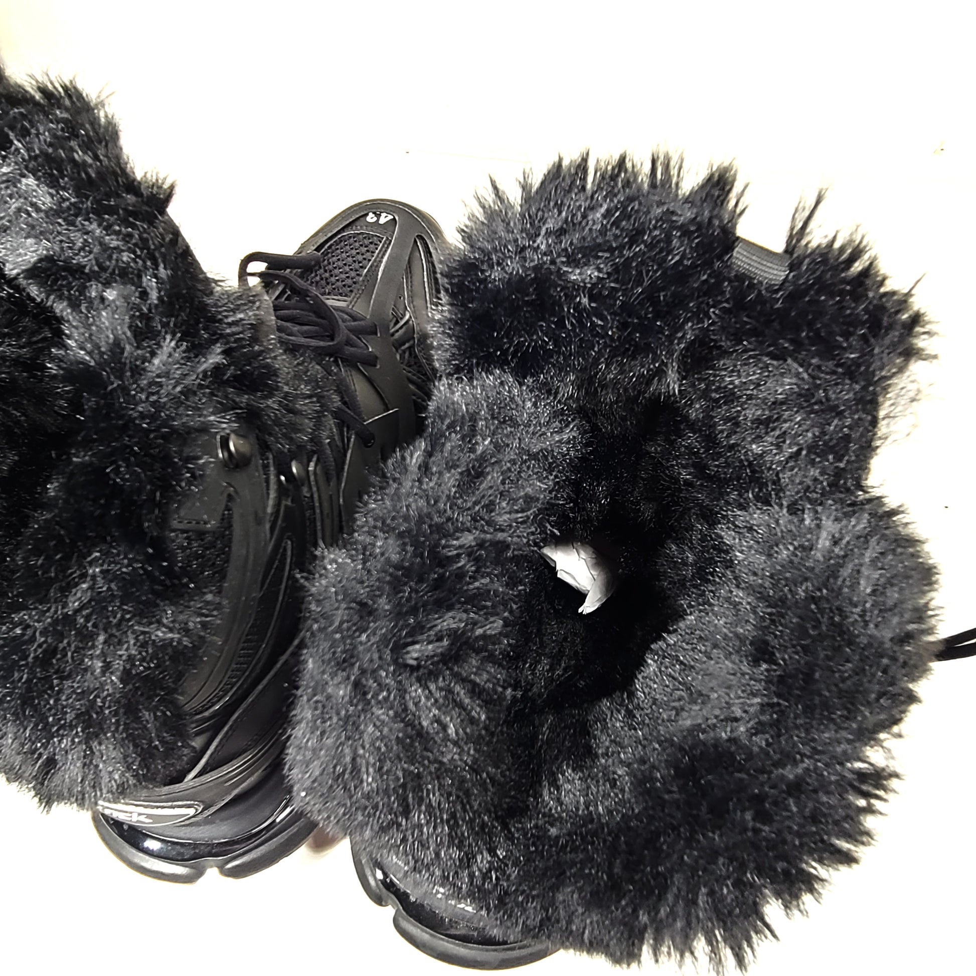 A pair of stylish men's black Balenciaga Track Sneakers with fur lining