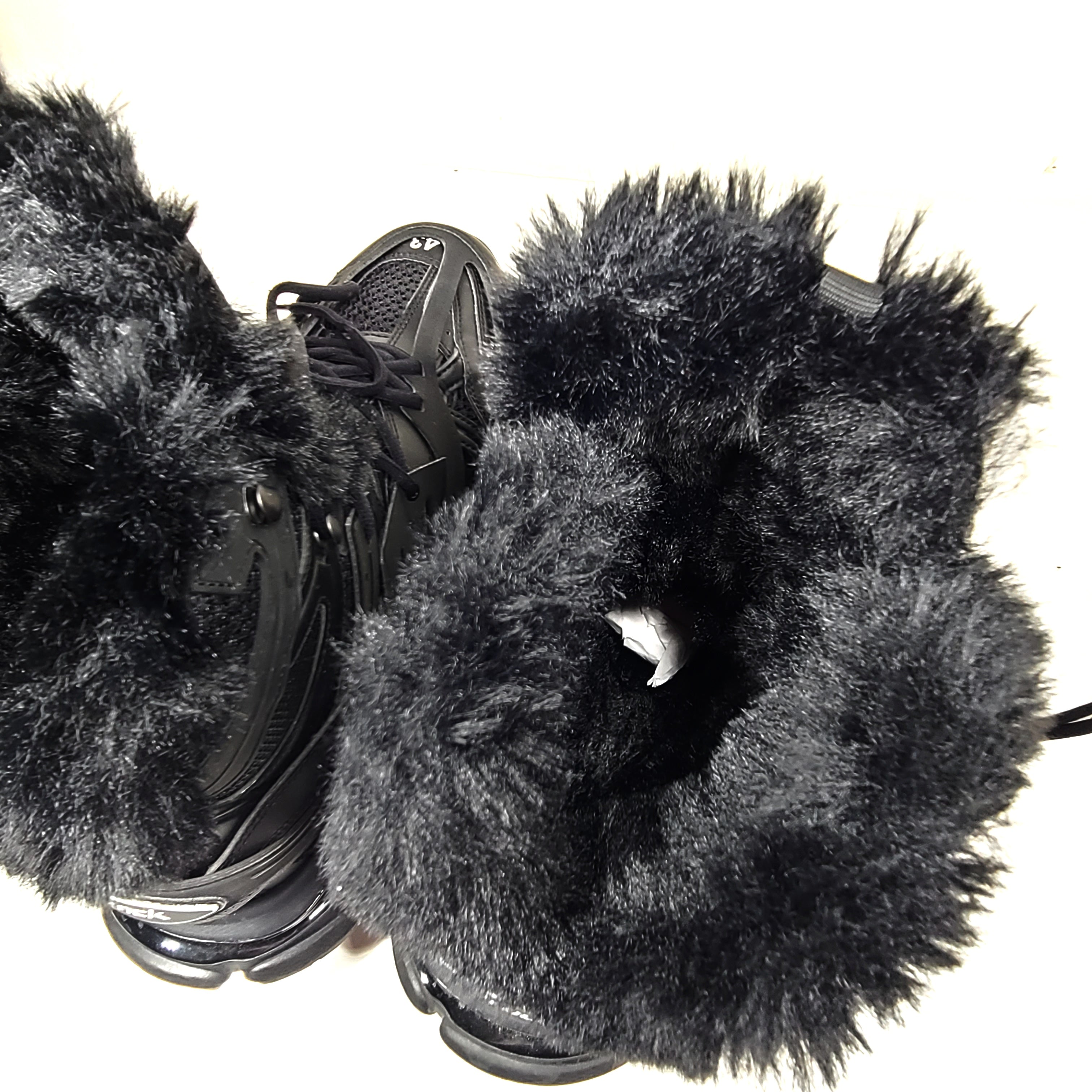 A pair of stylish men's black Balenciaga Track Sneakers with fur lining