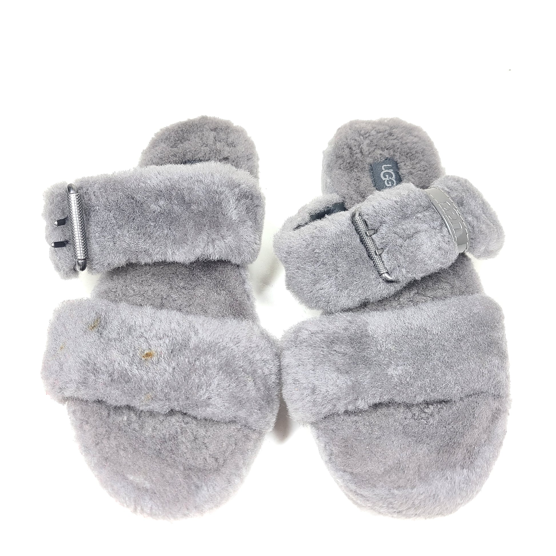 A pair of gray UGG Fluffy Sandals with adjustable straps in size 7.