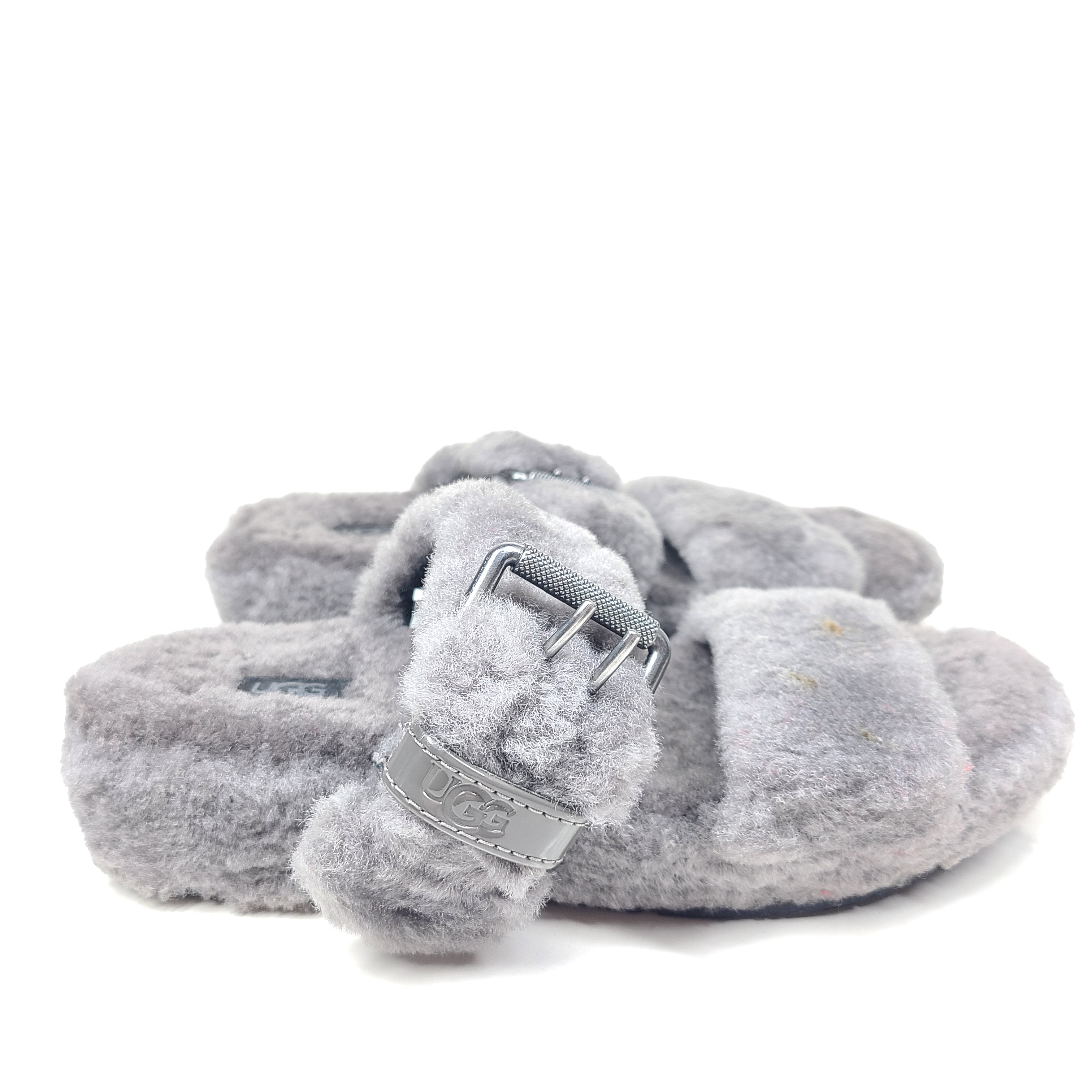 A pair of gray UGG Fluffy Sandals with adjustable straps in size 7.