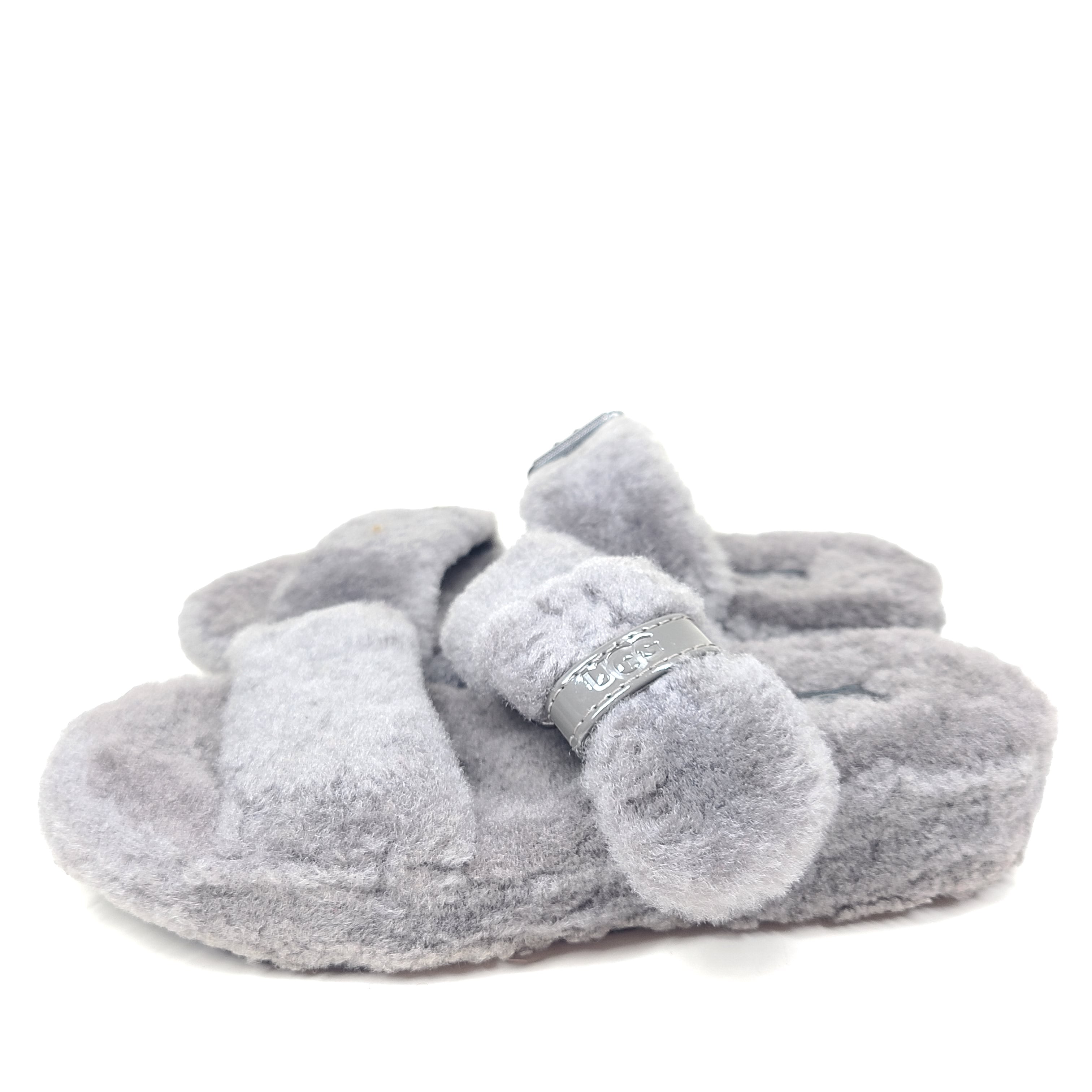 A pair of gray UGG Fluffy Sandals with adjustable straps in size 7.