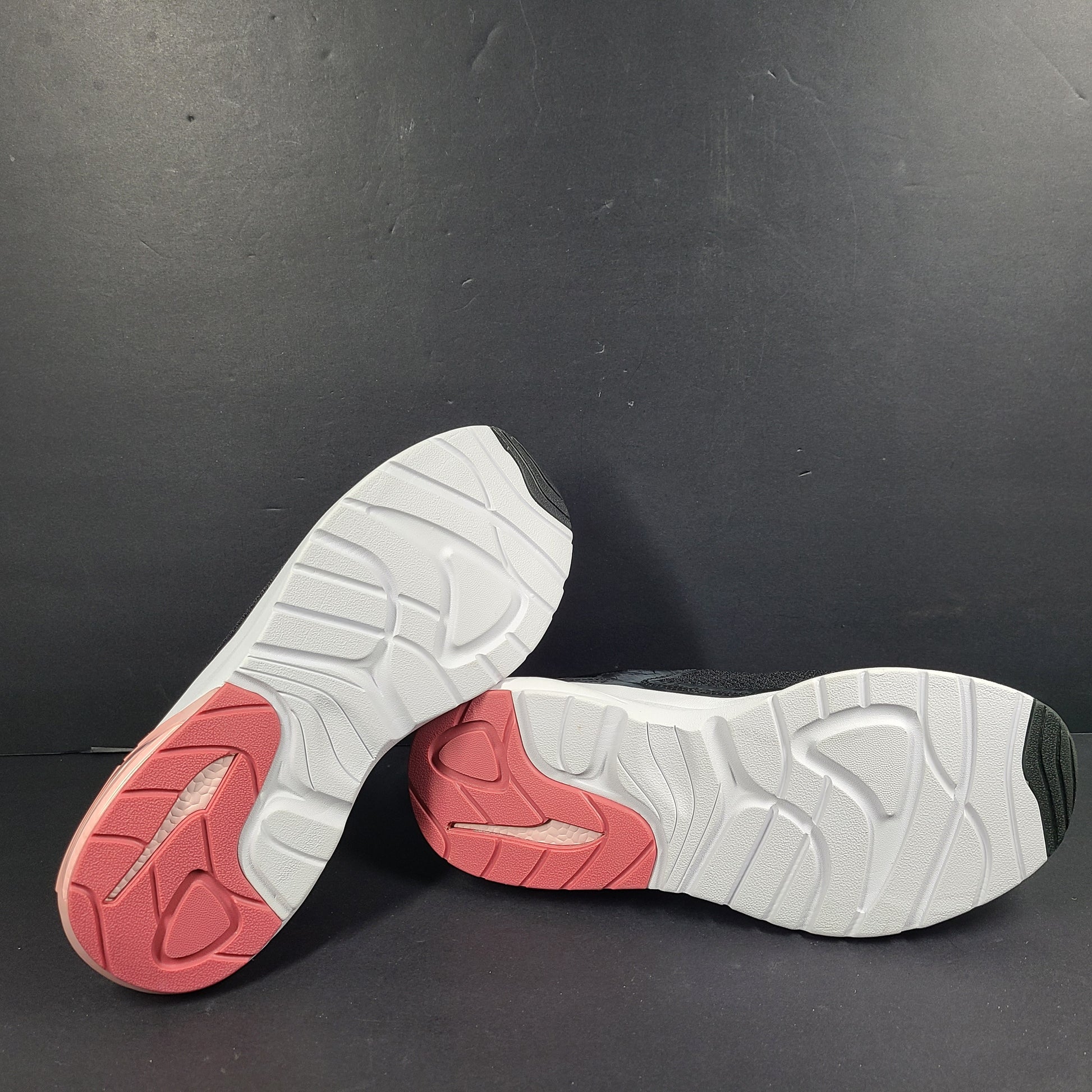 A pair of Puma black and pink sneakers with SoftFoam technology