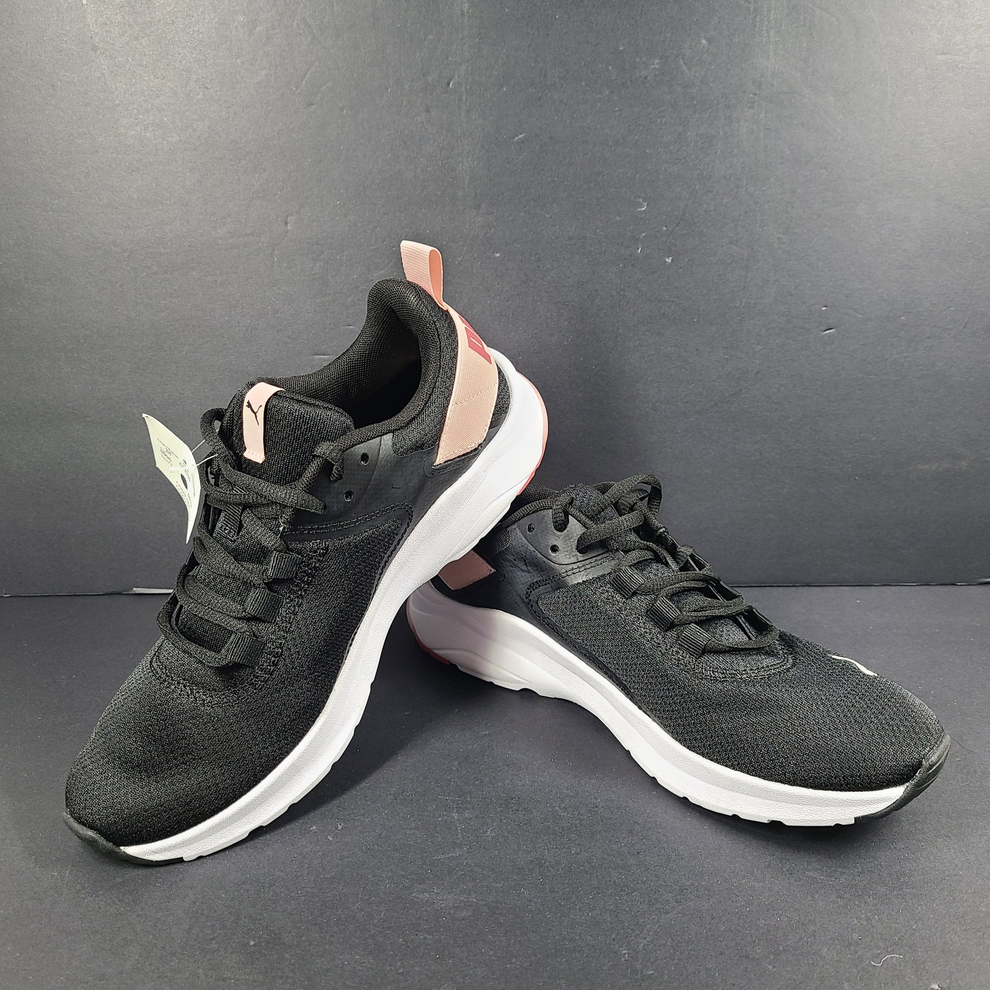 A pair of Puma black and pink sneakers with SoftFoam technology