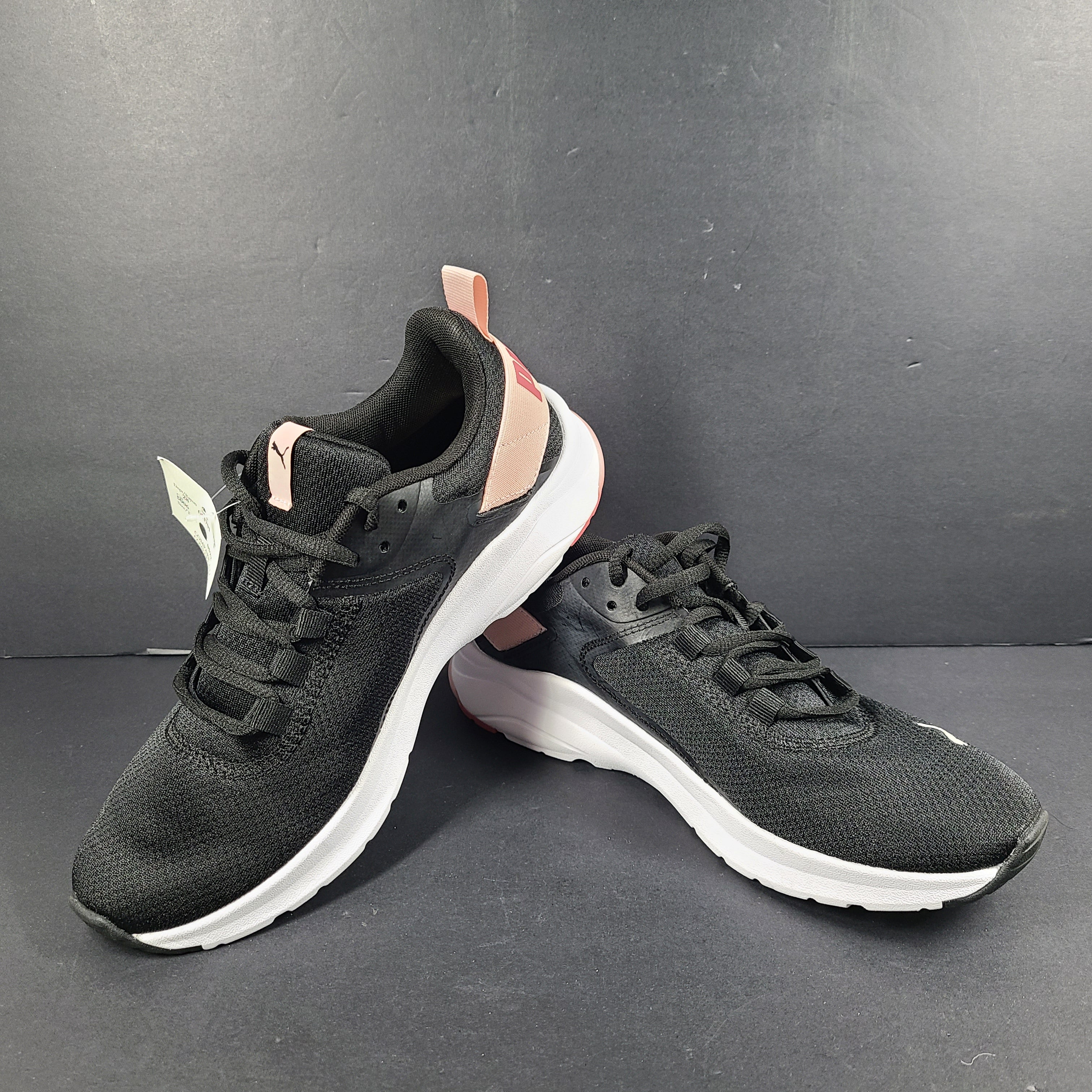 A pair of Puma black and pink sneakers with SoftFoam technology