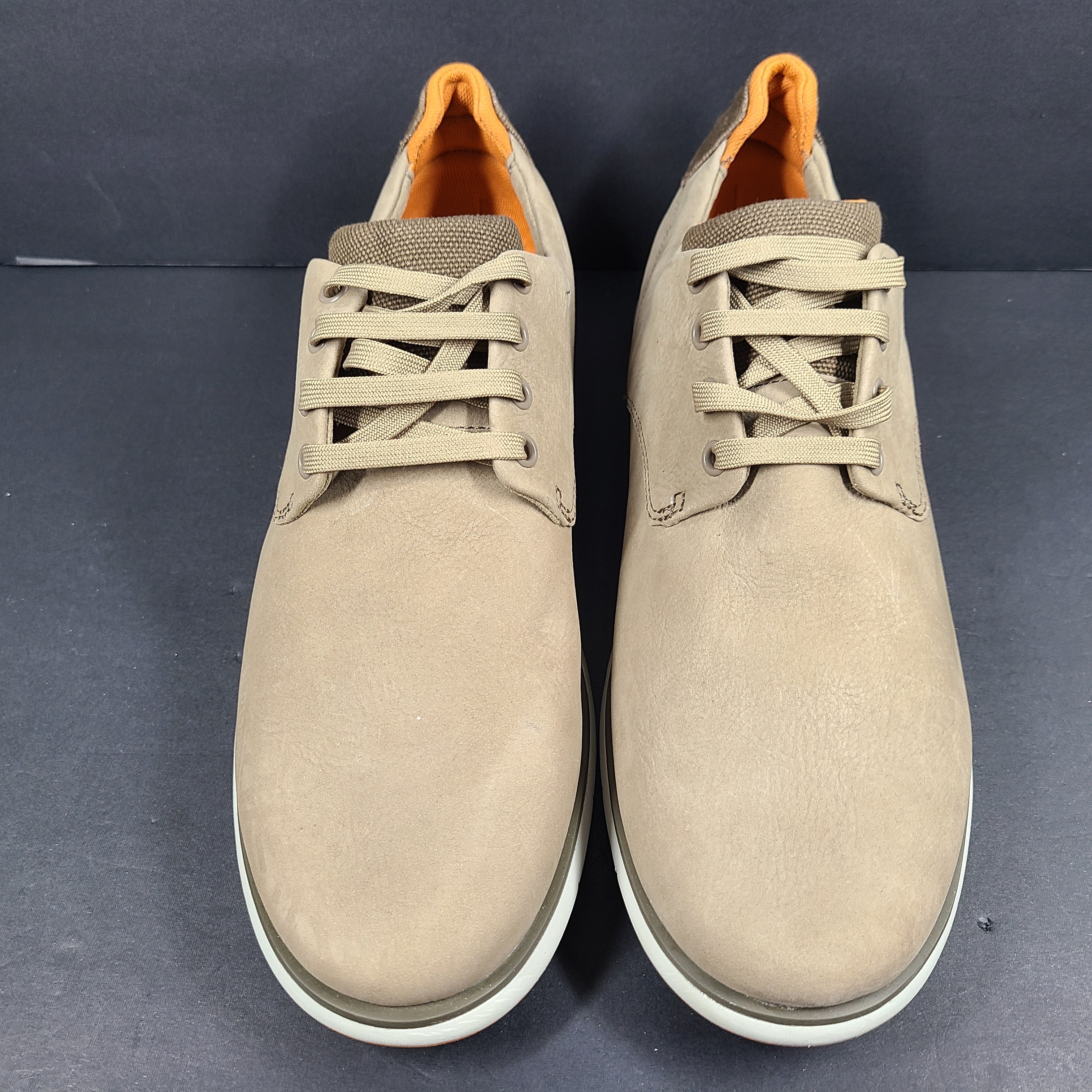 A pair of beige Camper men's casual shoes.