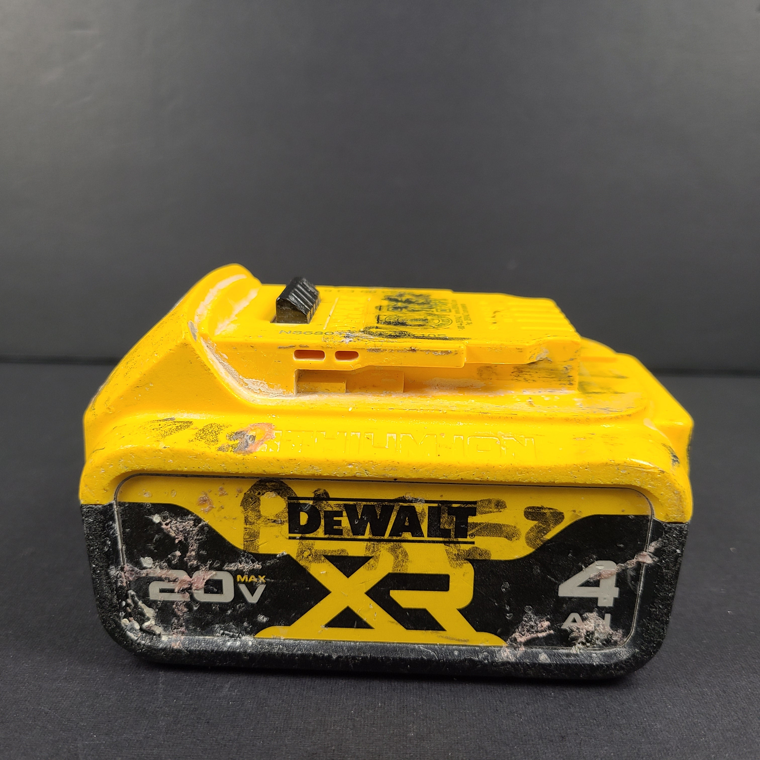 A pre-owned DeWalt XR Lithium-Ion Battery 20V Max 4Ah N089668 with noticeable wear.