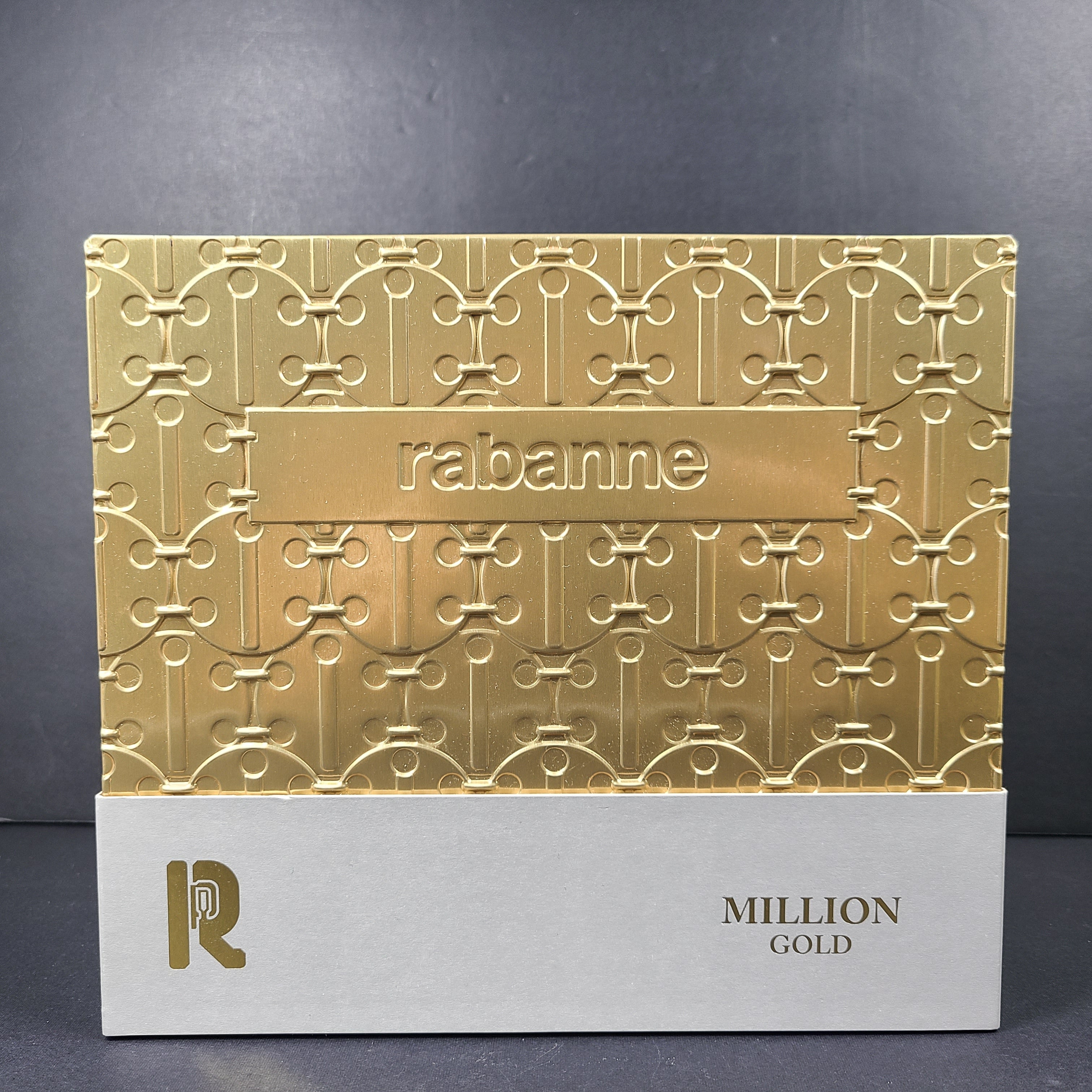 A luxurious gift set of Paco Rabanne fragrance products in gold packaging.