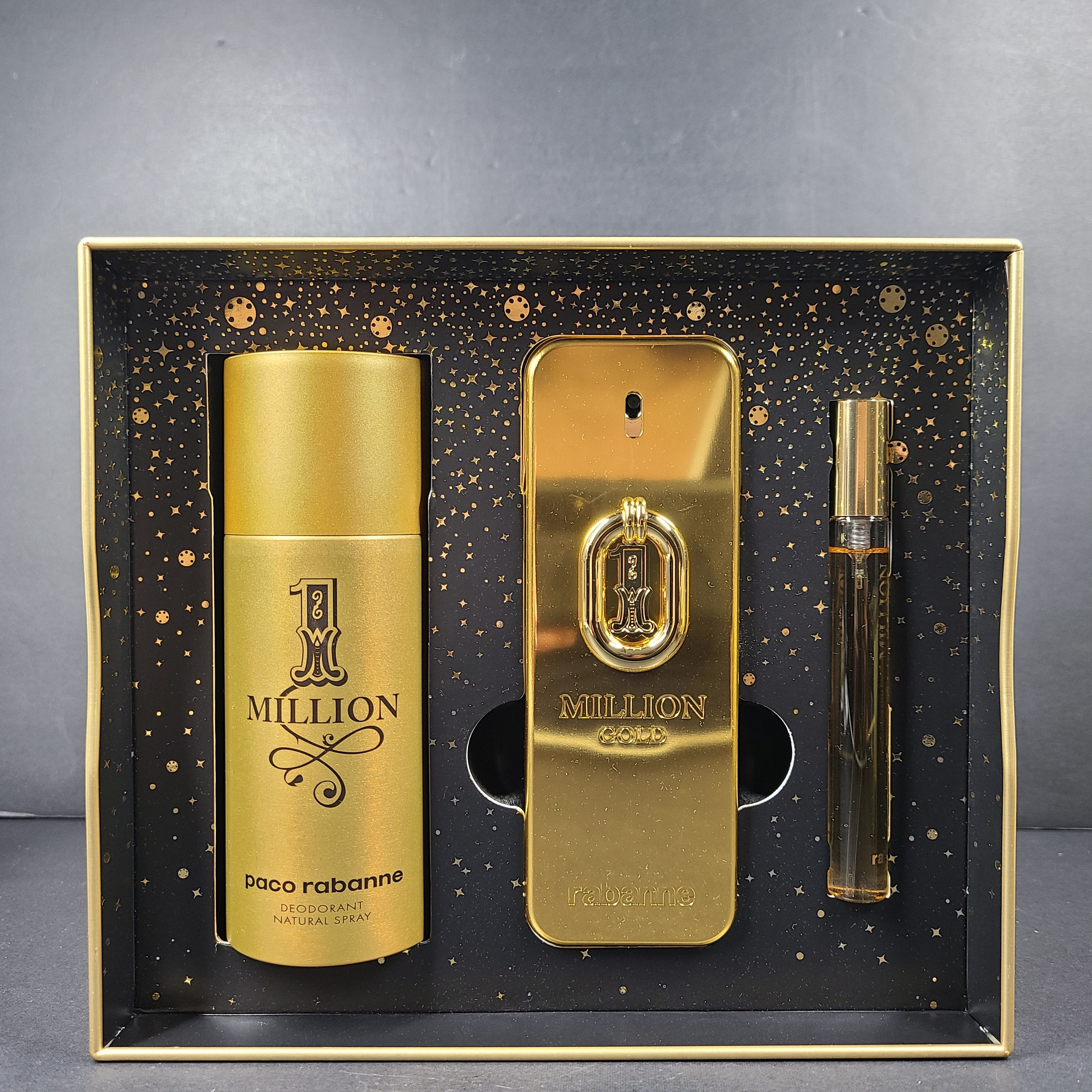 A luxurious gift set of Paco Rabanne fragrance products in gold packaging.