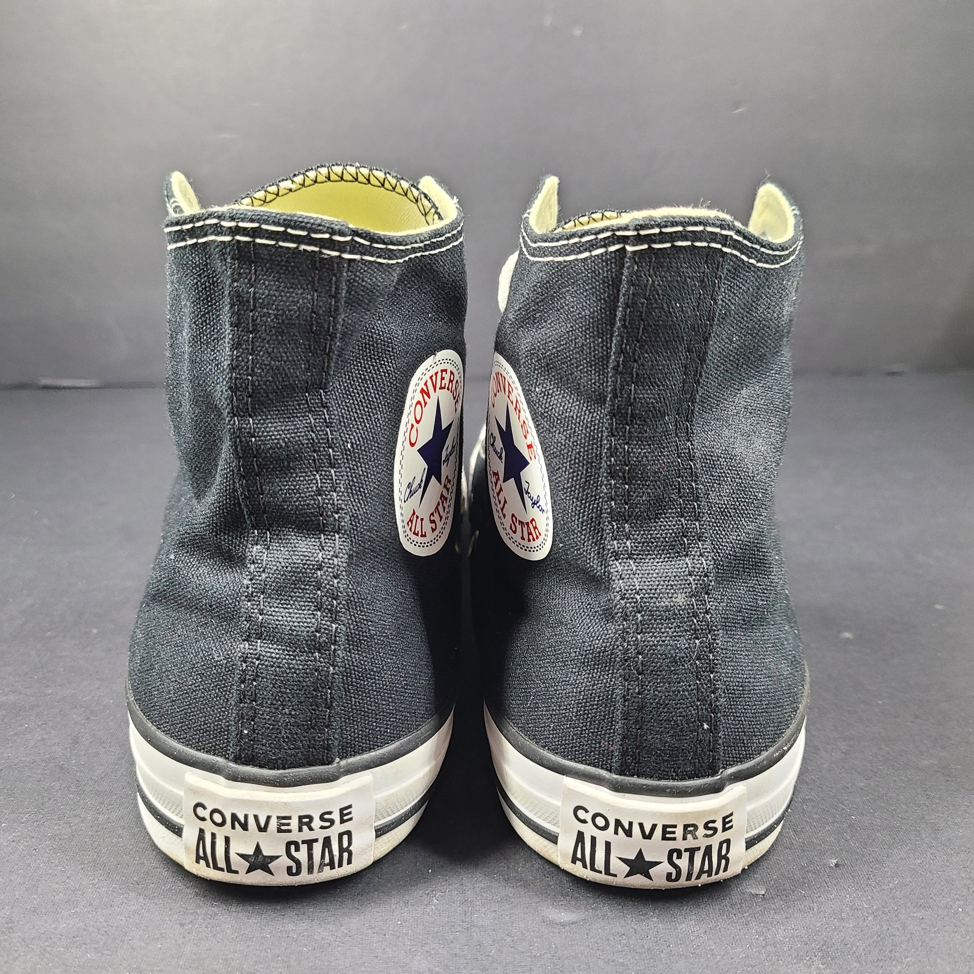 A pair of black Converse All Star High Top Sneakers for women in US Size 5.5