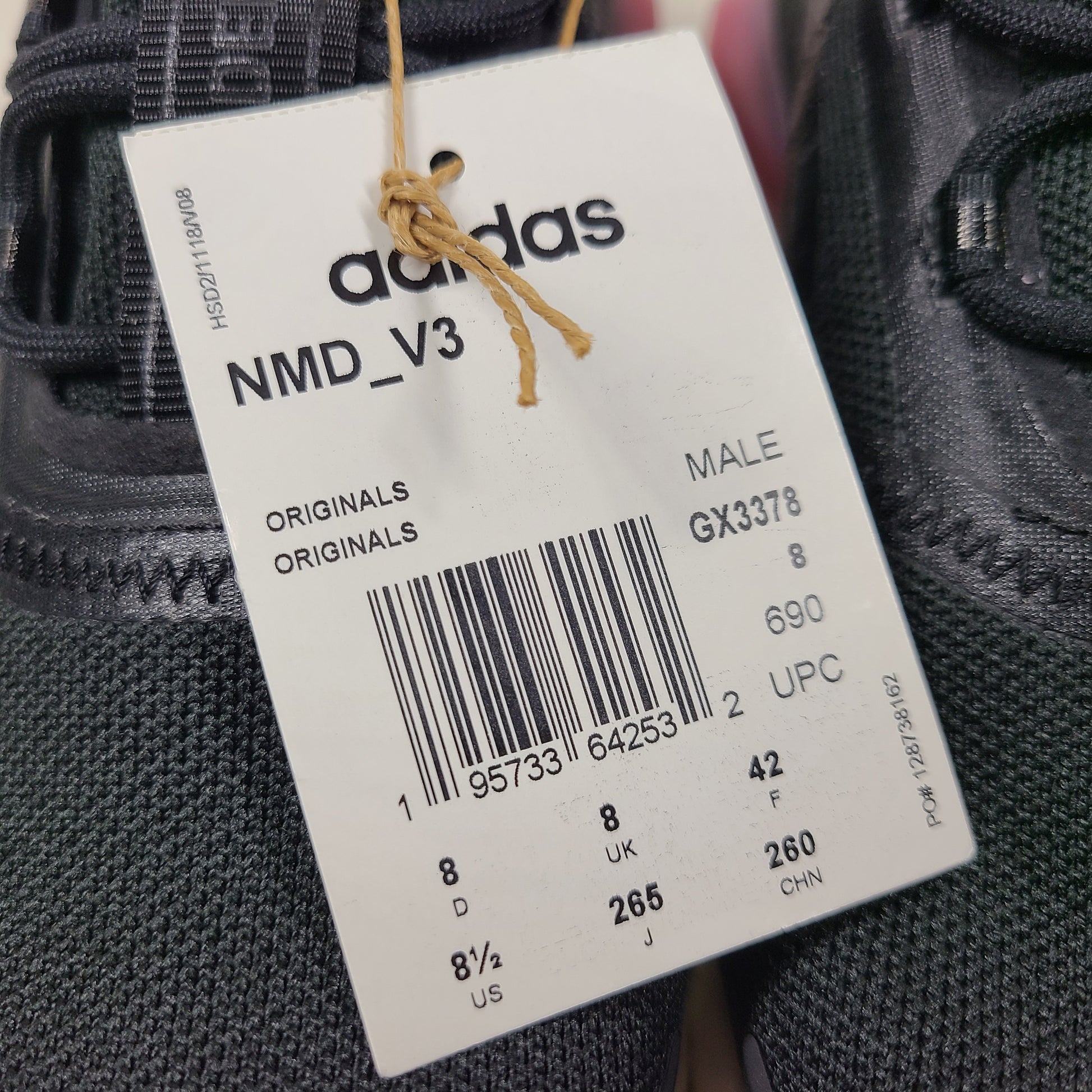A pair of Adidas NMD_V3 Originals Shoes in black, gold, and white color scheme