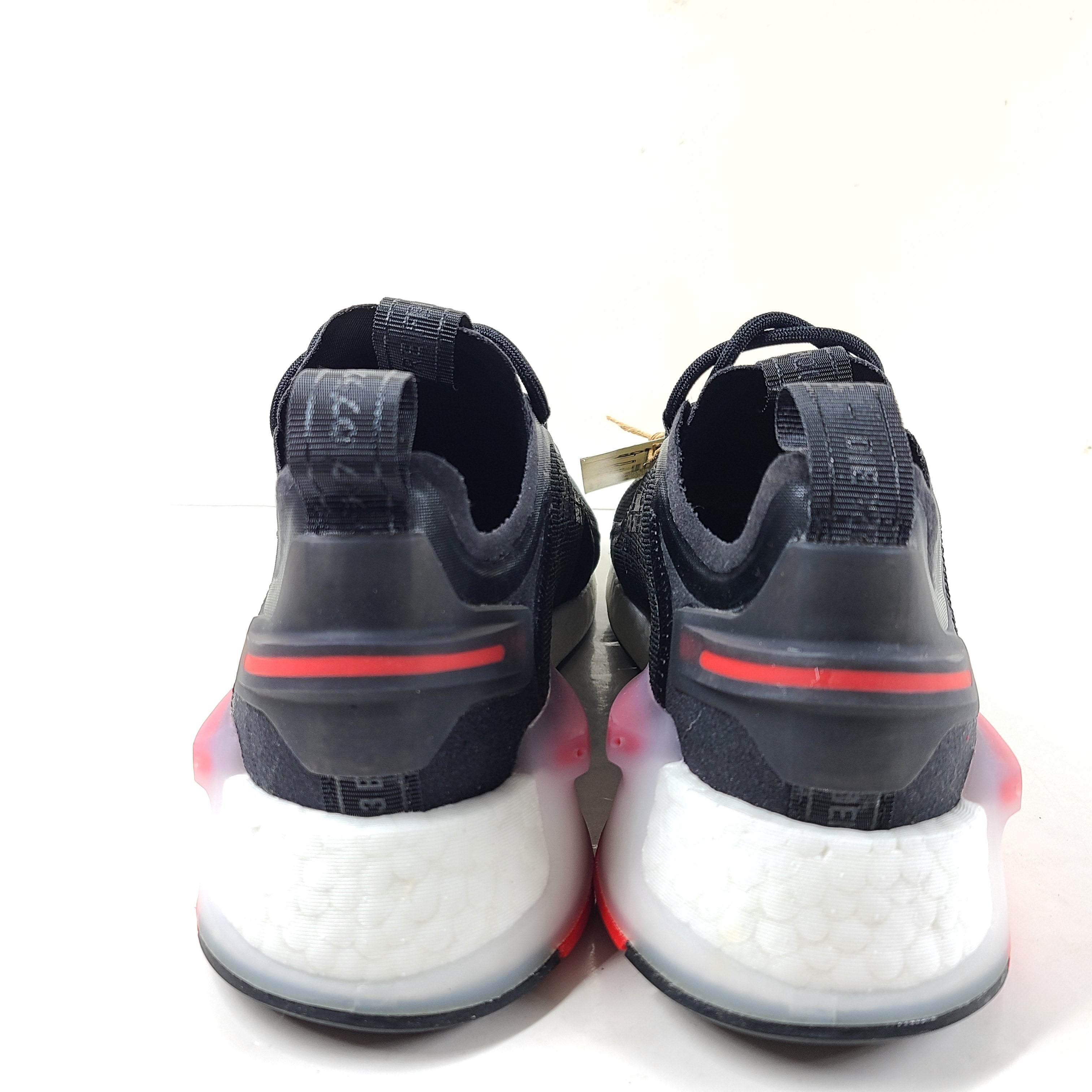 A pair of Adidas NMD_V3 Originals Shoes in black, gold, and white color scheme