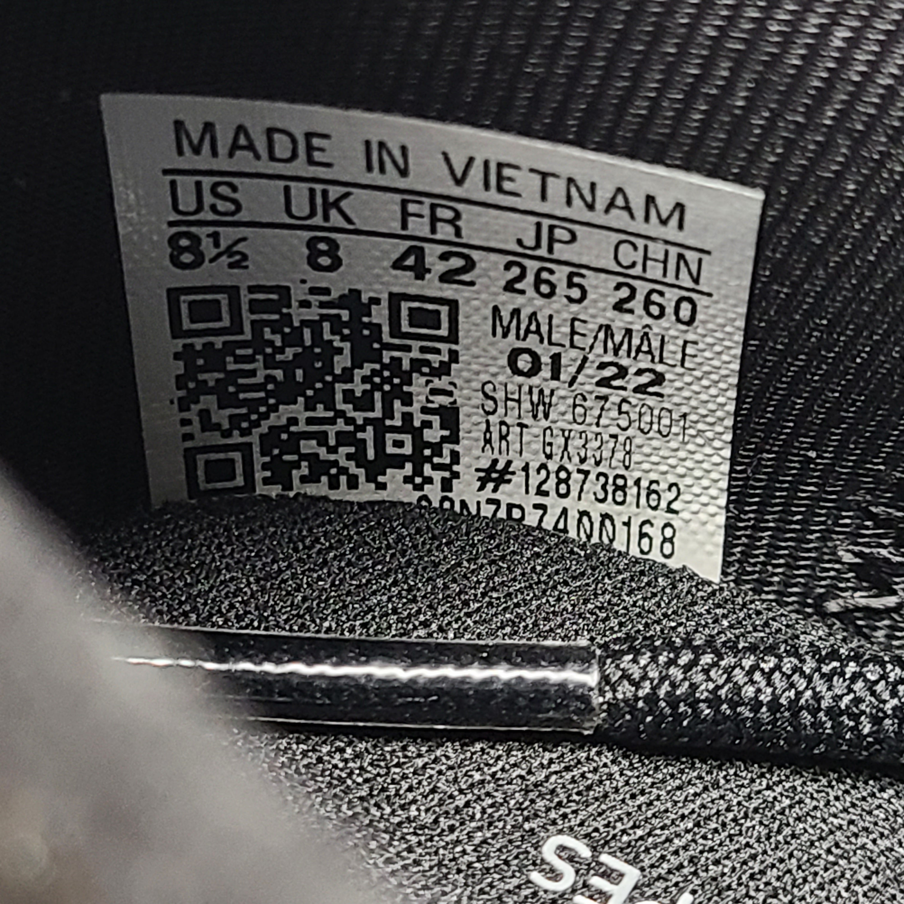 A pair of Adidas NMD_V3 Originals Shoes in black, gold, and white color scheme